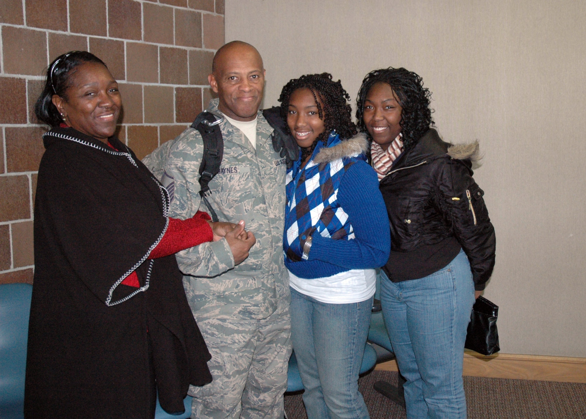 Master Sergeant Ricky Haynes of the 38th Aerial Port Squadron sees his family for the first time after completing a four month deployment.  (U.S. Air Force photo/Technical Sergeant Traci Johnson)