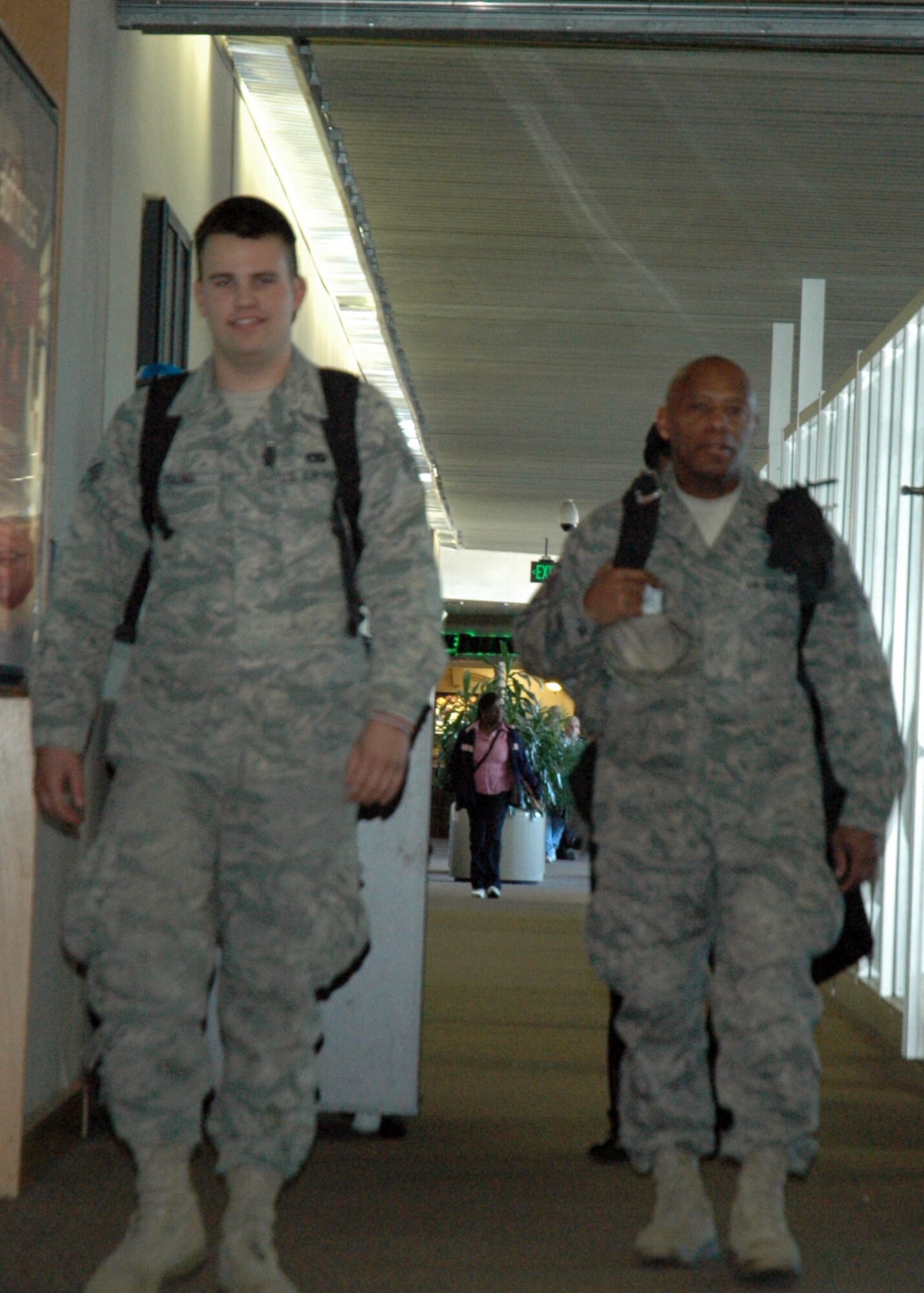 Master Sergeant Ricky Haynes and Senior Airman Braydon Young of the 315th Airlift Wing's 38th Aerial Port Squadron arrive at the Charleston Airport after completing a four month deployment.  (U.S. Air Force photo/Technical Sergeant Traci Johnson)