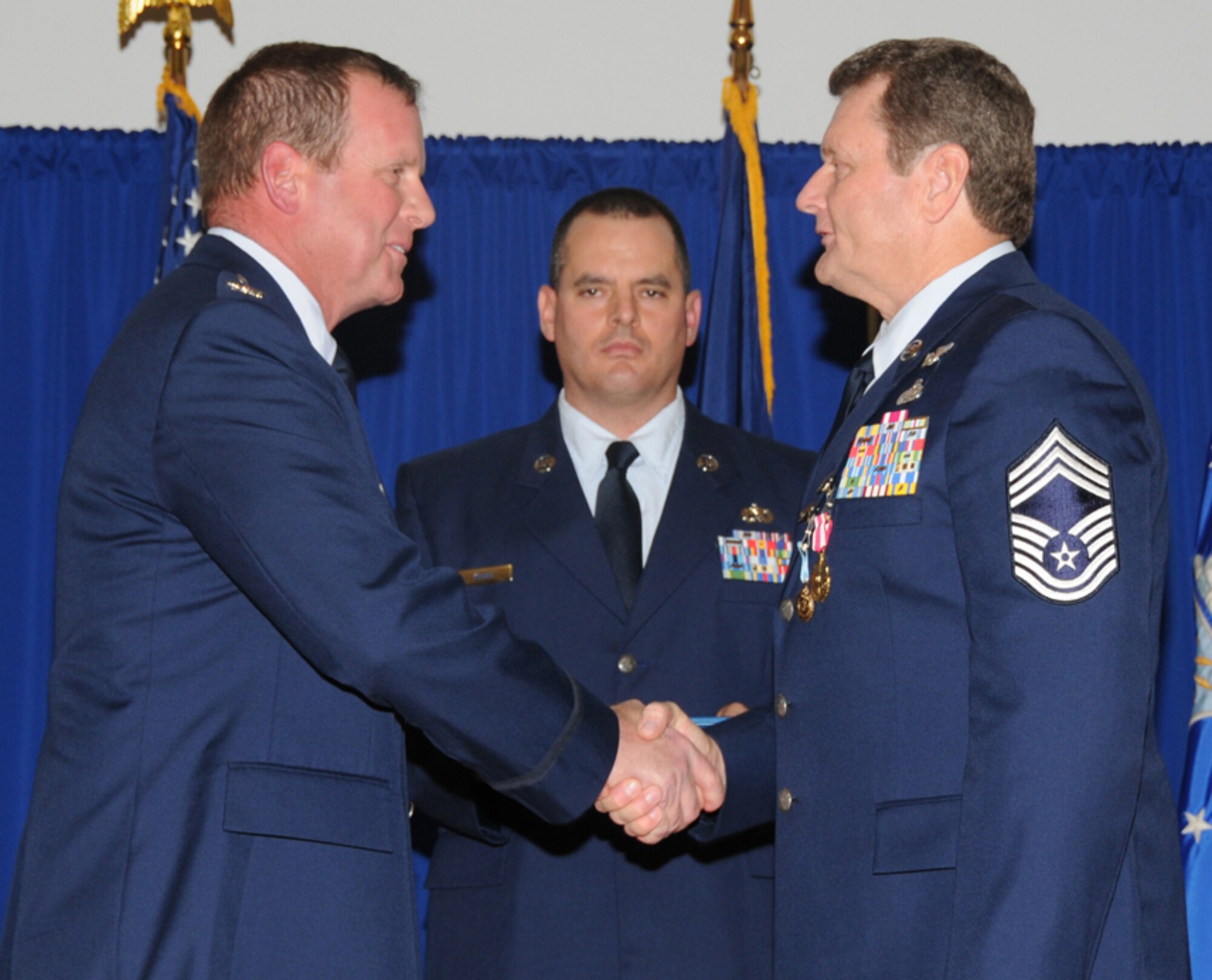 Col. Neil Mullaney, 123rd Maintenance Group commander, congratulates Chief Hall on his retirement.

(Photo by Airman 1st Class Max Rechel, Kentucky Air National Guard)