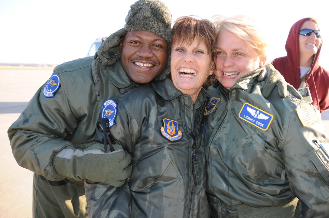 Master Sgt. Rico Walker (left) and Lt. Col. Lenora Cook (right) congratulate
Lt. Col. Sally Bird after she touched down (and was splashed with water) following
her last aeromedical flight aboard a KC-135.   Colonel Bird has been with 932nd Aeromedical Squadron for 18 years at Scott Air Force Base. She is retiring with 28 years total service and has logged some 2,906 flying hours.