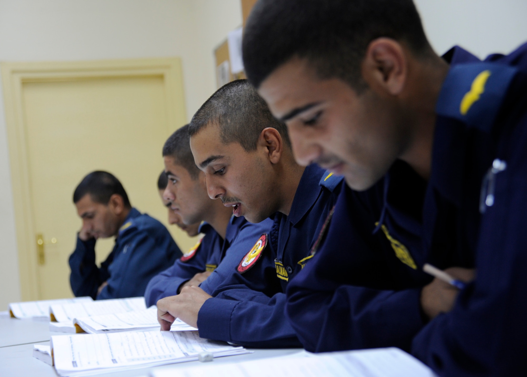 RUSTAMIYAH, Iraq -- An Iraqi cadet reads aloud from his workbook during an English language course at the Iraqi Air Force Training Wing, Forward Operating Base Rustamiyah, Iraq. (U.S. Air Force photo/Staff Sgt. Paul Villanueva II)