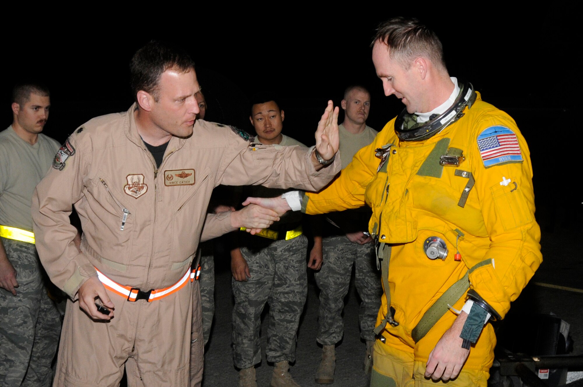 SOUTHWEST ASIA -- Lt. Col. Vincent Catich, 99th Expeditionary Reconnaissance Squadron, commander, tacks a 2000 hour patch onto Major Thomas Ryan, 99th Expeditionary Reconnaissance Squadron, mission pilot, Jan. 9. Maj. Ryan was met by leadership and fellow 99th ERS personnel to congratulate him on becoming the 25th pilot to reach the 2000 hour milestone behind the helm of a U-2 Dragonlady. Maj. Ryan is deployed to the 380th Air Expeditionary Wing from the 9th Reconnaissance Squadron, Beale AFB, Calif. and hails from Sneads Ferry, N.C. Calif. Lt. Col. Catich is from Aurora, Ill. (U.S. Air Force photo by Senior Airman Brian J. Ellis)(Released)