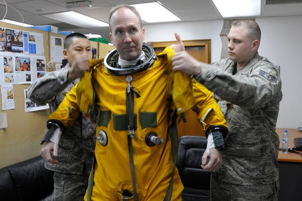 SOUTHWEST ASIA -- Major Thomas Ryan, 99th Expeditionary Reconnaissance Squadron, mission pilot, is suited up to be pressurized by Staff Sgt. Mark Reith and Senior Airman David Sivixay, 99th Expeditionary Reconnaissance Squadron, Physiological Support Division,  prior to his 2000 hour flight at the helm of a U-2 Dragonlady, Jan. 9. Maj. Ryan is the 25th pilot to reach the 2000 hour milestone.  All three members are from the 9th Reconnaissance Squadron, Beale AFB, Calif. Maj. Ryan is from Sneads Ferry, N.C., Sergeant Reith is from Flint, Mich. And Airman Sivixay is from San Diego, Calif. (U.S. Air Force photo by Senior Airman Brian J. Ellis)(Released)