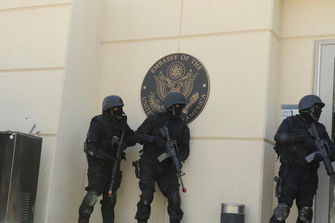 Kuwaiti National Guard members get set to enter the U.S. Embassy, Kuwait during a bilateral training exercise. The unit retook the embassy from Marines posing as an opposition force. The event was designed to identify vulnerabilities in the embassy's security.