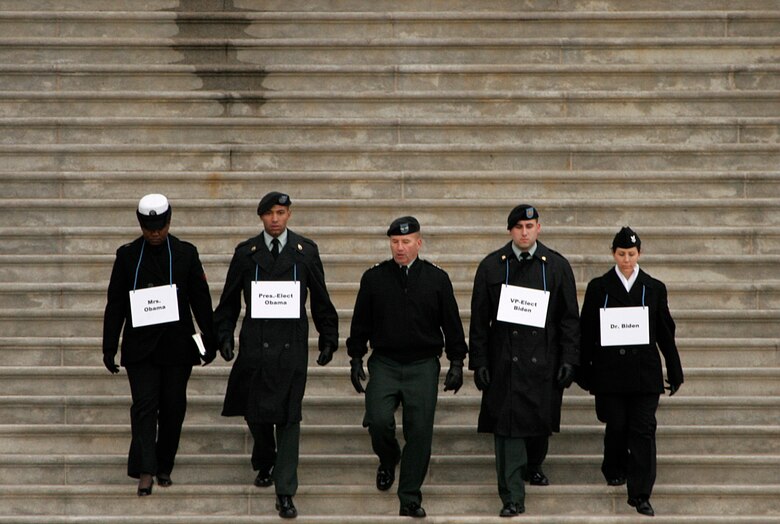 Military stand-ins for the 56th Presidential Inaugural Rehearsal walk down the eastside steps of the Capitol building toward a VH-60 helicopter Jan. 11. Army Staff Sgt. Derrick Brooks, 741st Military Intelligence, and a Fayetteville, N.C., native, stood in for President-elect Barrack Obama. Navy Seaman LaSean McCray, a Miami native, played the role of Michelle Obama. Playing the part of Vice President-elect Joe Biden was Army Spc. Nicholas Rupple, a native of Fairfax, Va. Standing in for Jill Biden was Navy Petty Officer 2nd Class Karen Lowden, a native of Cambridge, Ohio. Army Maj. Gen. Richard J. Rowe, Joint Force Headquarters National Capital Region, (middle) acted as himself.