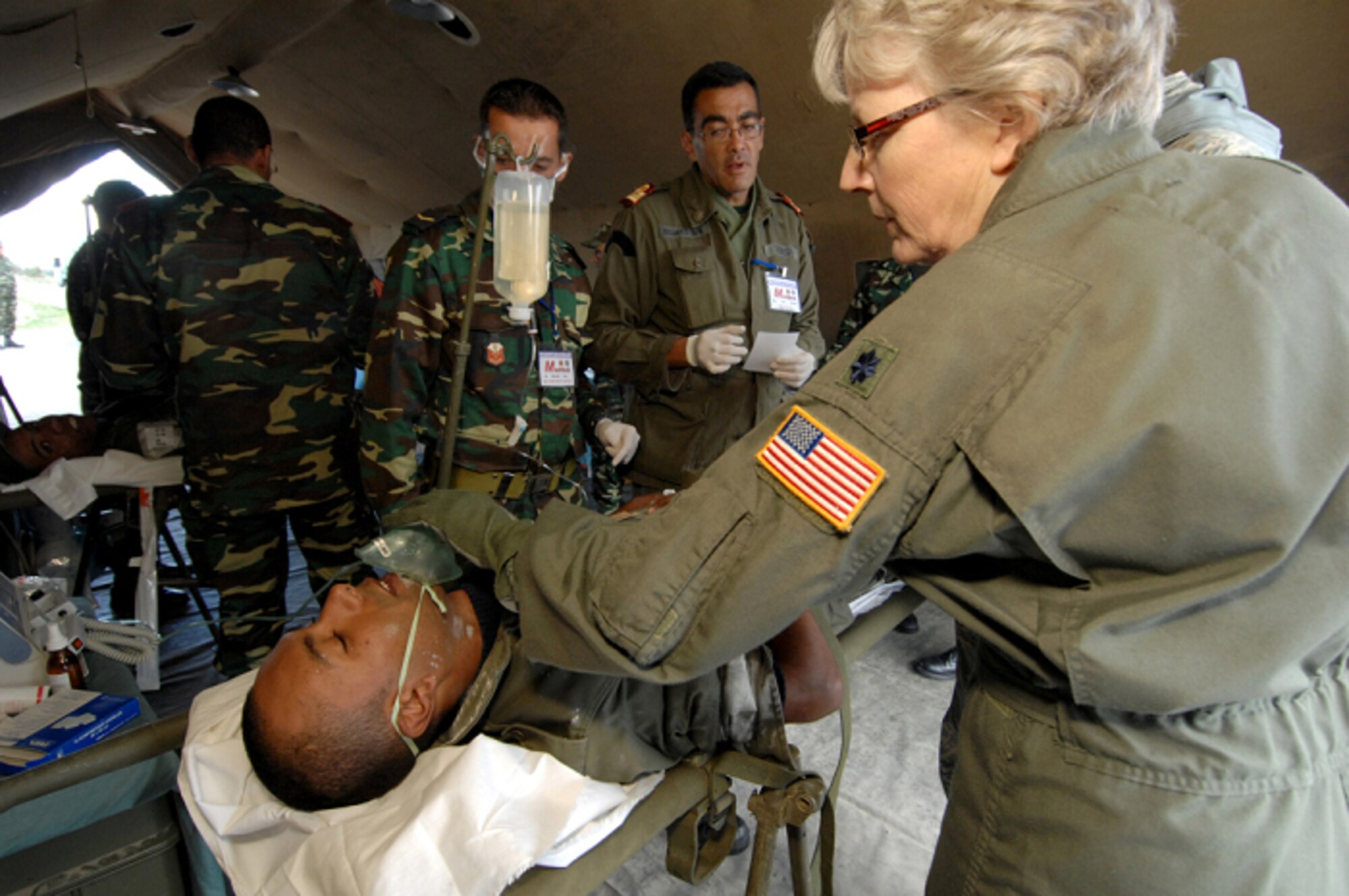 KHARROUBA AIR BASE, Tunisia -- U.S. Air Force Lt. Col. Margaret Schmidt (right), Chief Nurse from the 459th Aeromedical Evacuation Squadron, Andrews Air Force Base, Md., applies a simple face oxygen mask to a simulated victim during a mock Nov. 17 during Medlite 2008. Medlite is a Joint Chiefs of Staff Exercise designed to provide and exchange medical skills, techniques and procedures between members of the U.S. Air Force, U.S. Army and Tunisian Military Health Services. (U.S. Air Force photo/Senior Airman Erica Knight)