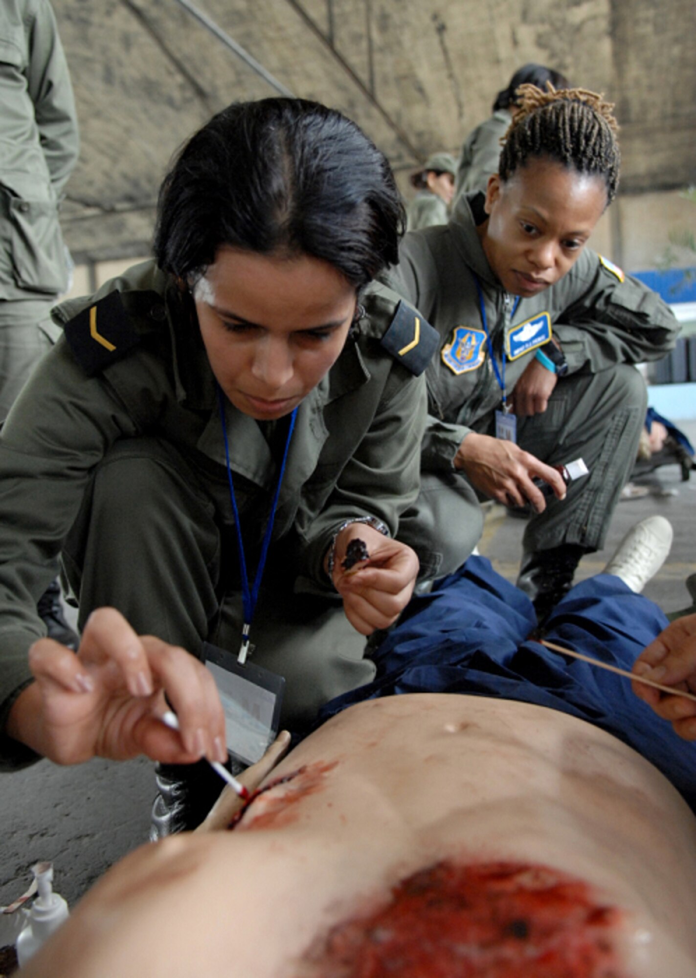 KHARROUBA AIR BASE, Tunisia -- U.S. Air Force Senior Master Sgt. Phyllis Pierce (right) from the 459th Aeromedical Evacuation Squadron, Andrews Air Force Base, Md., supervises as Tunisian Sgt. Aida Hazami applies burn and wound moulage to a simulated victim at Kharrouba Air Base, Tunisia, Africa Nov.14 during Medlite 2008.  Medlite is a Joint Chiefs of Staff Exercise designed to provide and exchange medical skills, techniques and procedures between members of the U.S. Air Force, U.S. Army and Tunisian Military Health Services. (U.S. Air Force photo by Senior Airman Erica Knight)