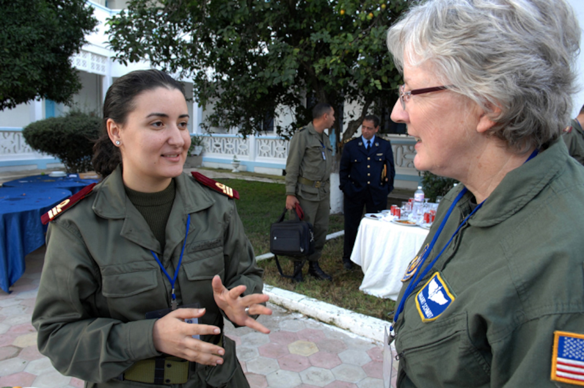 KHARROUBA AIR BASE, Tunisia -- U.S. Air Force Lt. Col. Margaret Schmidt, (right) Chief Nurse from the 459th Aeromedical Evacuation Squadron, Andrews Air Force Base, Md., discusses American customs with Tunisian Navy Hematologist Capt. Imen Mzougui at Kharrouba Air Base, Tunisia, during Medlite 2008.  Medlite is a Joint Chiefs of Staff Exercise designed to provide and exchange medical skills, techniques and procedures between members of the U.S. Air Force, U.S. Army and Tunisian Military Health Services. (U.S. Air Force photo by Senior Airman Erica Knight)