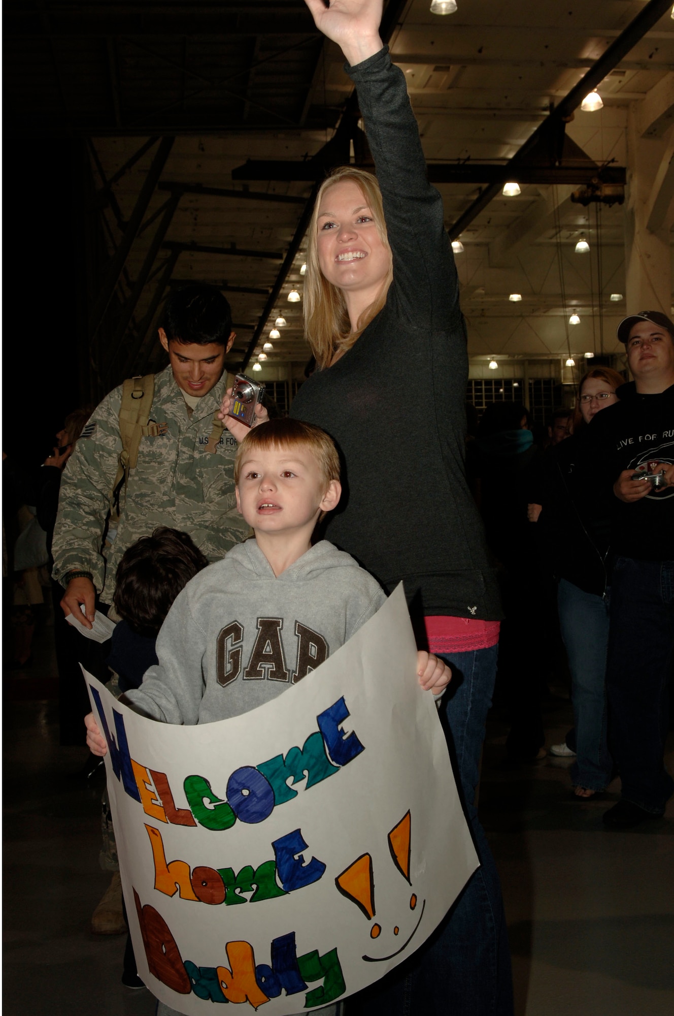 A family sees their returning Airman at Operation Homecoming at Eglin Air Force Base, Fla., Jan. 8.  Operation Homecoming brings Hurlburt Airmen returning from deployment face to face with waiting family members as soon as they step off the plane. (U.S. Air Force photo by Airman First Class Matt Loken)