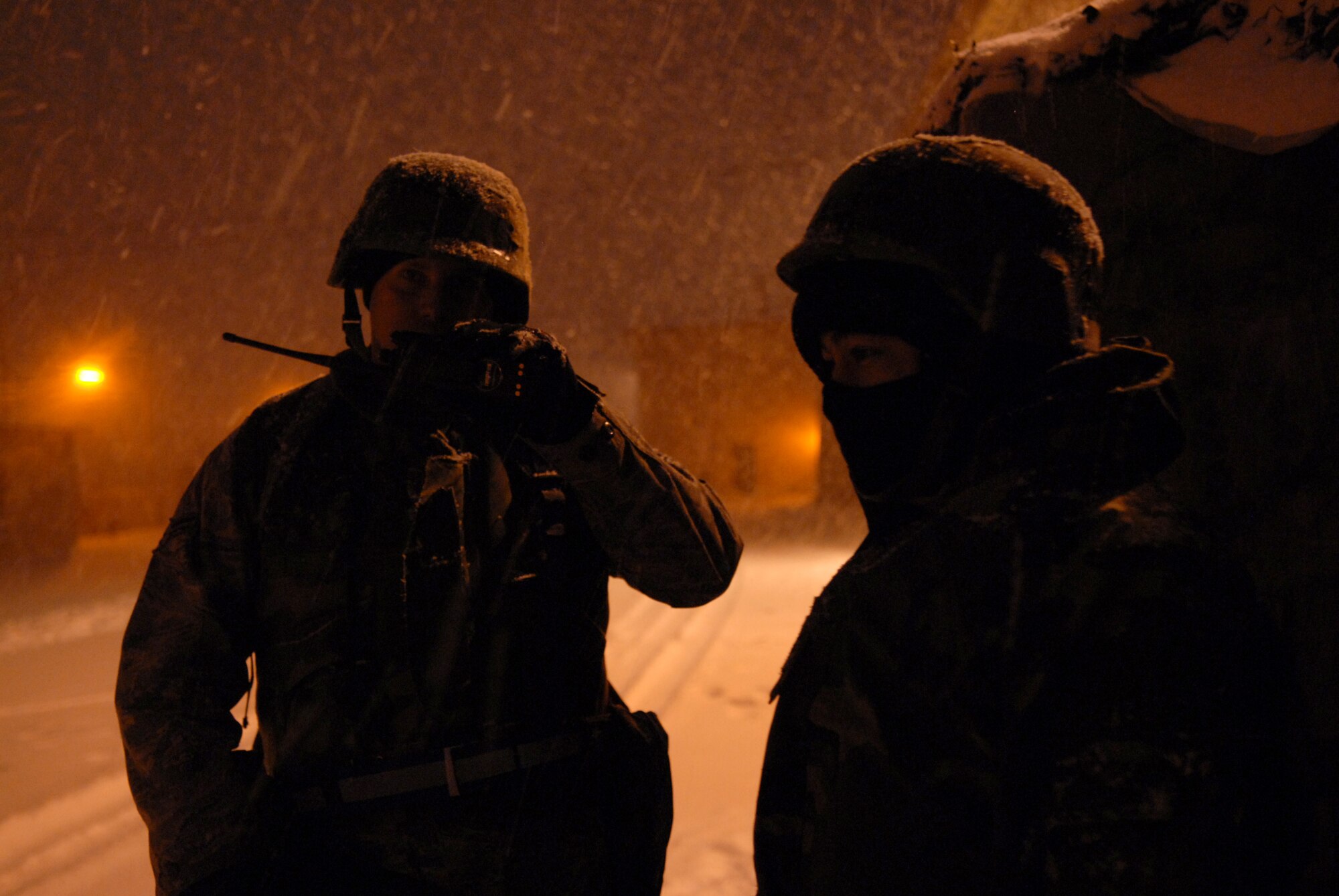 Airman 1st Class Christopher Neal, 8th Logistics Readiness Squadron, communicates his status to his Unit Control Center as Senior Airman Bryan Feuerstein, 8th LRS, waits for instructions during the Peninsula-Wide Operational Readiness Exercise  Beverly Bulldog 09-01 at Kunsan Air Base, Republic of Korea, Jan. 12, 2009. The PENORE will test the wolf pack on its wartime capabilities and response actions in preparation for an upcoming Operational Readiness Inspection. (U.S. Air Force Photo by Senior Airman Angela Ruiz)  