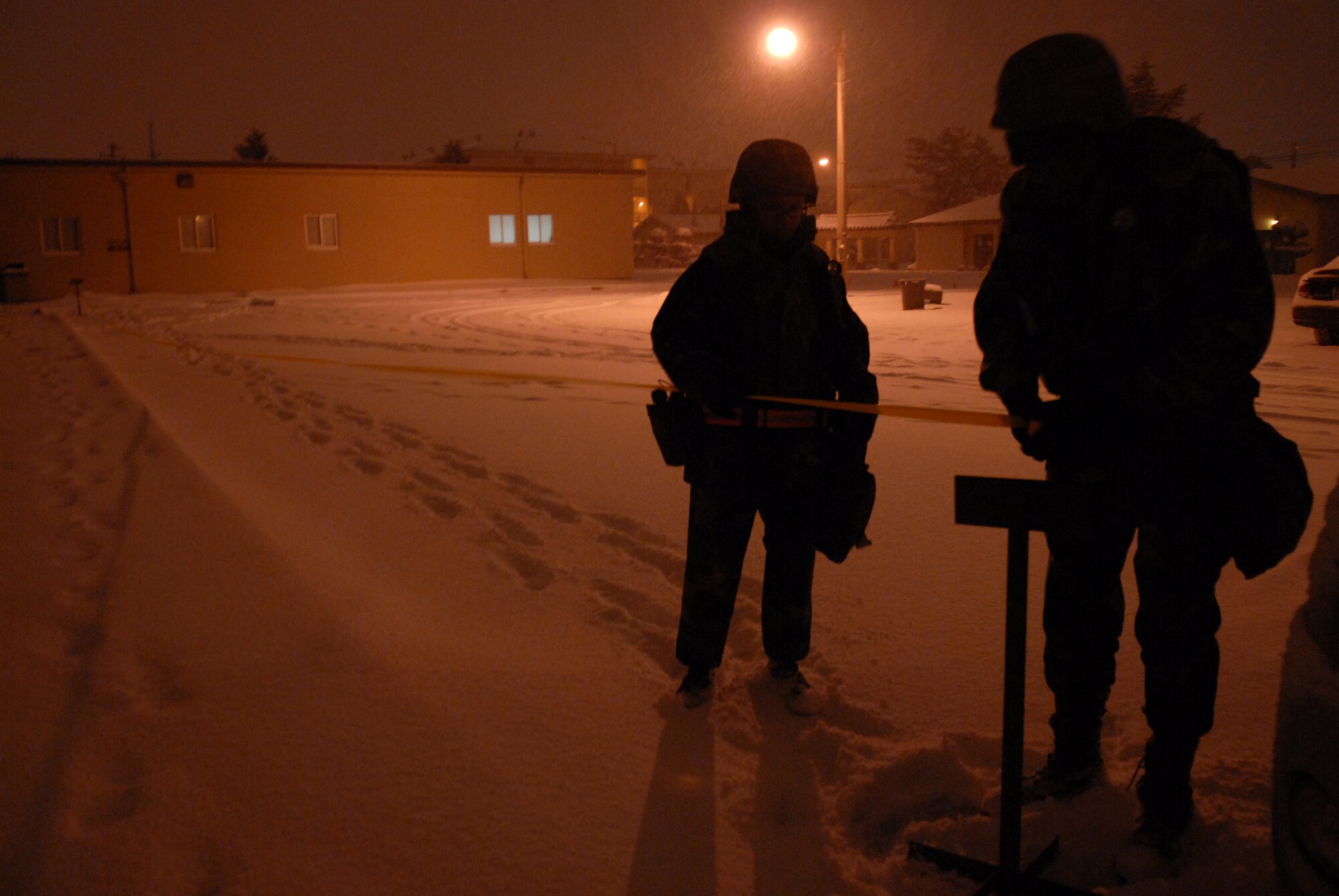 Technical Sgt. Shana Stewart and Staff Sgt. Kenneth Henson, 8th Force Support Squadron cordon the area around a building during thePeninsula-Wide Operational Readiness Exercise Beverly Bulldog 09-01at Kunsan Air Base, Republic of Korea, Jan. 12, 2009. The PENORE will test the wolf pack on its wartime capabilities and response actions in preparation for an upcoming Operational Readiness Inspection. (U.S. Air Force Photo by Senior Airman Angela Ruiz)  