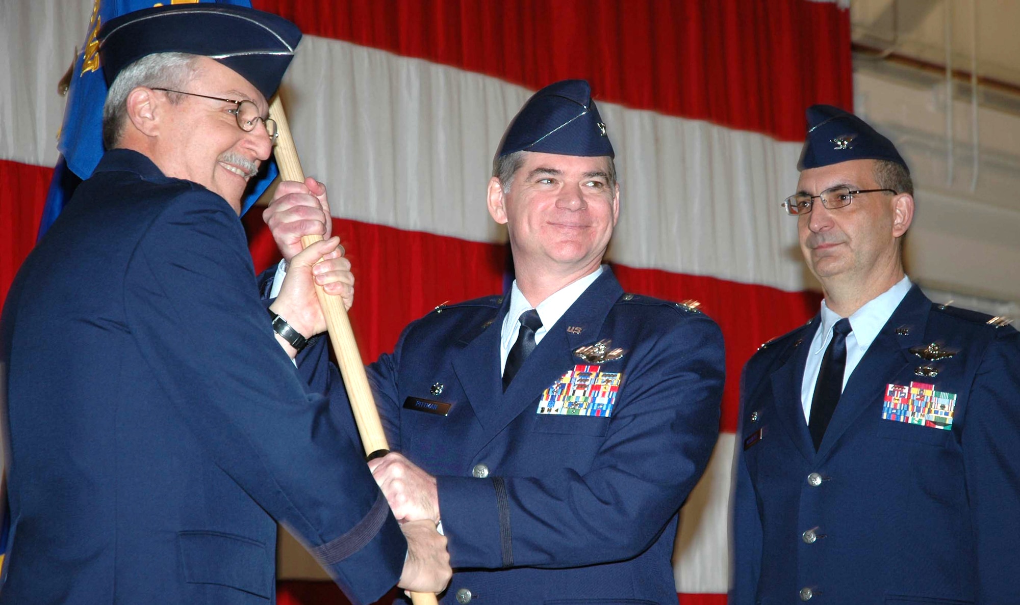 Maj. Gen. Martin M. Mazick, 22nd Air Force commander (left) presents Col. Jack H. Pittman, Jr. (center), with the 302nd Airlift Wing guideon during a change of command ceremony Jan. 10 at Peterson Air Force Base, Colo. Colonel Pittman relieved Col. James J. Muscatell Jr., who later went on to become the commander of the 403rd Wing at Keesler AFB, Miss. (U.S. Air Force photo/Tech. Sgt. Daniel Butterfield)