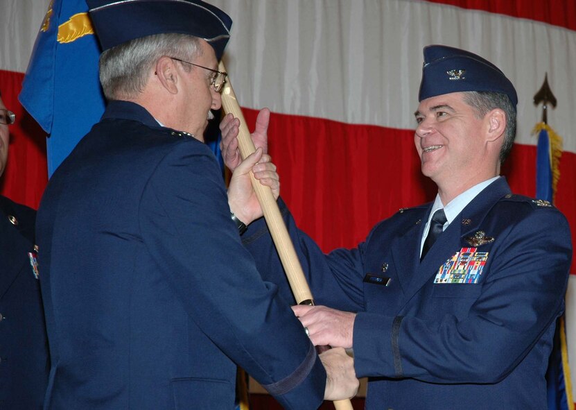 Maj. Gen. Martin M. Mazick, 22nd Air Force commander, hands over the 302nd Airlift Wing guideon to Col. Jack H. Pittman, Jr., during a change of command ceremony Jan. 10 at Peterson Air Force Base, Colo. Colonel Pittman recently became commander of the 302nd AW. (U.S. Air Force photo/Tech. Sgt. Daniel Butterfield)