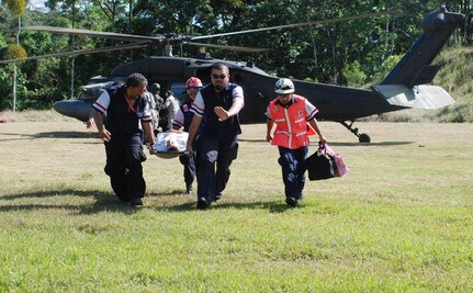 SAN MIGUEL, COSTA RICA — Members of the Costa Rican Red Cross transport a 65-year-old female earthquake victim here from a Joint Task Force-Bravo helicopter to a waiting ambulance Saturday.  Four JTF-Bravo helicopters and 34 servicemembers are deployed here from Soto Cano Air Base, Honduras, at the request of the Costa Rican government to provide life-saving support to those affected by the earthquake.  (U.S. Air Force photo/1st Lt. Candace Park)