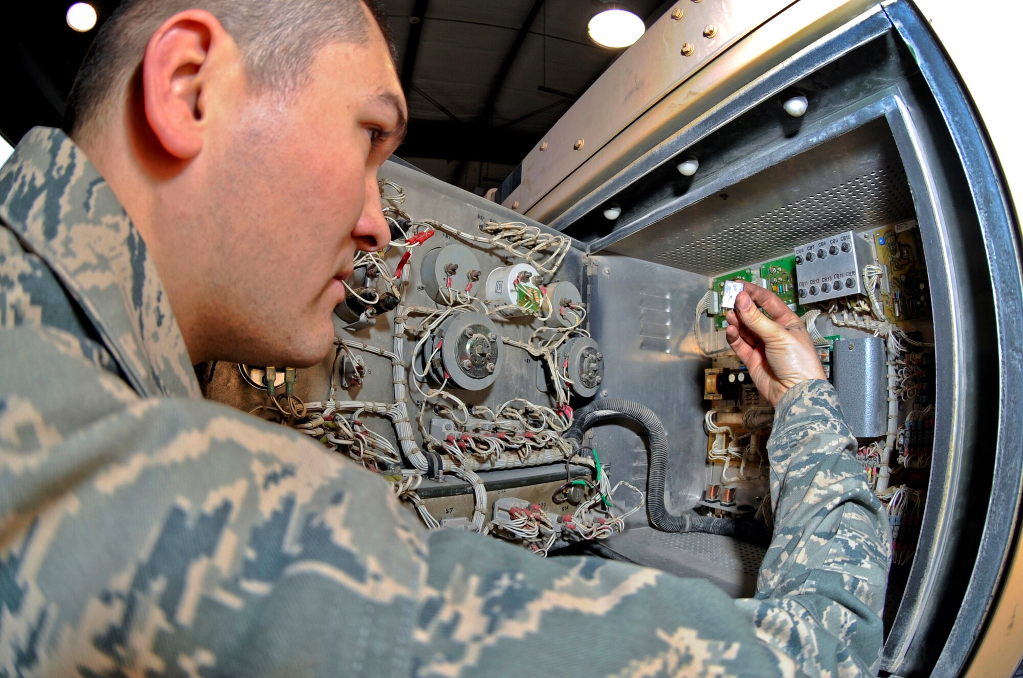 Senior Airman Bryan Hunt, an Aircraft Ground Equipment mechanic with the 379th Expeditionary Maintenance Squadron, inspects the relay switches for an A/M32A-103 Generator Set here, Jan. 10, 2009 in an undisclosed location in Southwest Asia. By making sure the relay switches are operating properly Airman Hunt is able to ensure the generator can provide power to the aircraft. The AGE shop owns and maintains over 590 pieces of equipment. Airman Hunt is a native of Ft Mill, S.C. and is deployed from Tinker Air Force Base, Okla., in support of Operations Iraqi and Enduring Freedom and Joint Task Force-Horn of Africa. (U.S. Air Force Photo by Staff Sgt. Joshua Garcia/Released)