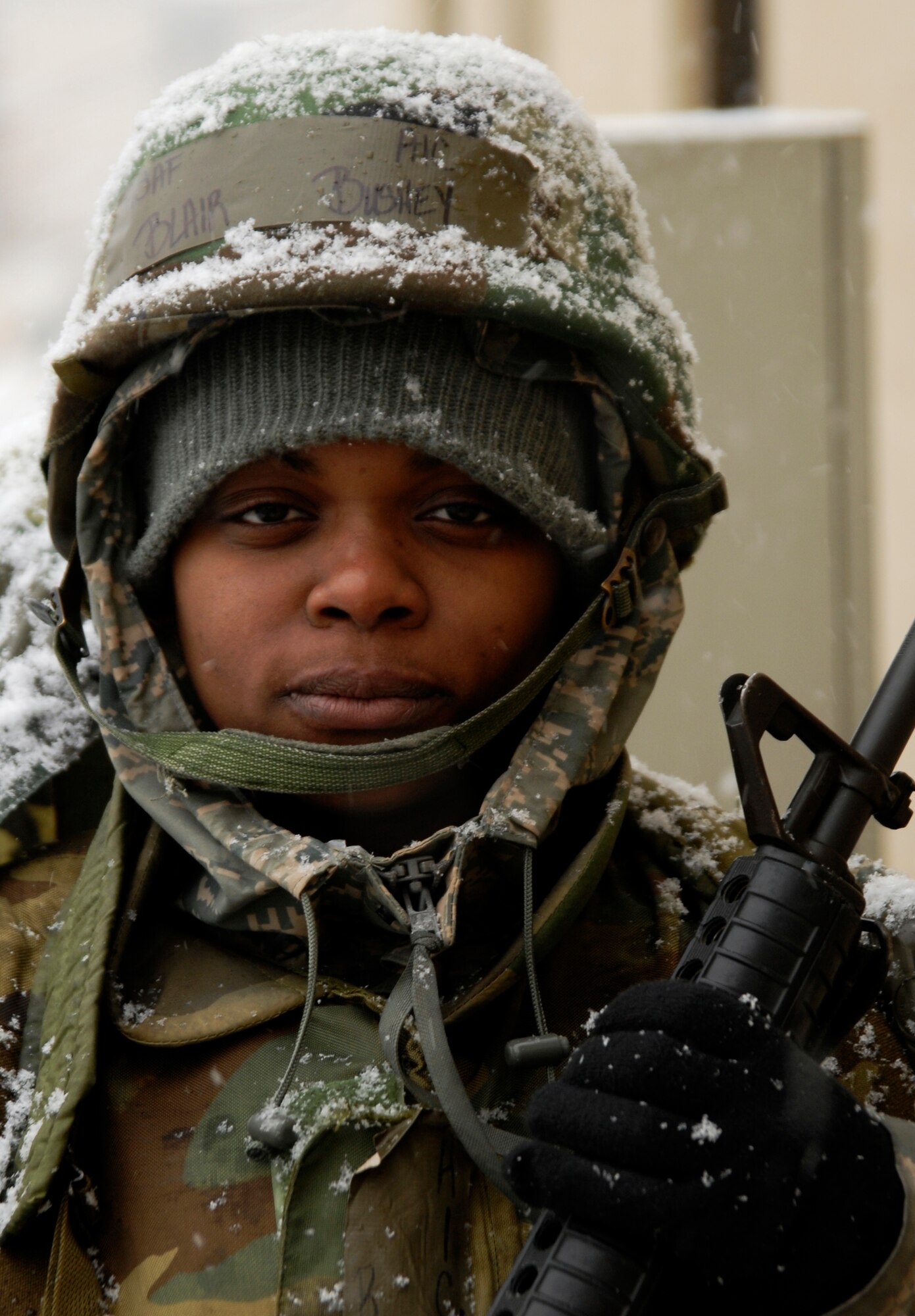 Senior Airman Blair Bushey, 8th Force Support Squadron, watches for threats from a defensive fighting position while snow accumulates on her during the Peninsula Wide Operational Readiness Exercise at Kunsan Air Base, Republic of Korea, Jan. 11, 2009. Kunsan is participating in the PENORE as a test of its wartime capabilities and response actions. (U.S. Air Force Photo by SSgt Jason Colbert)