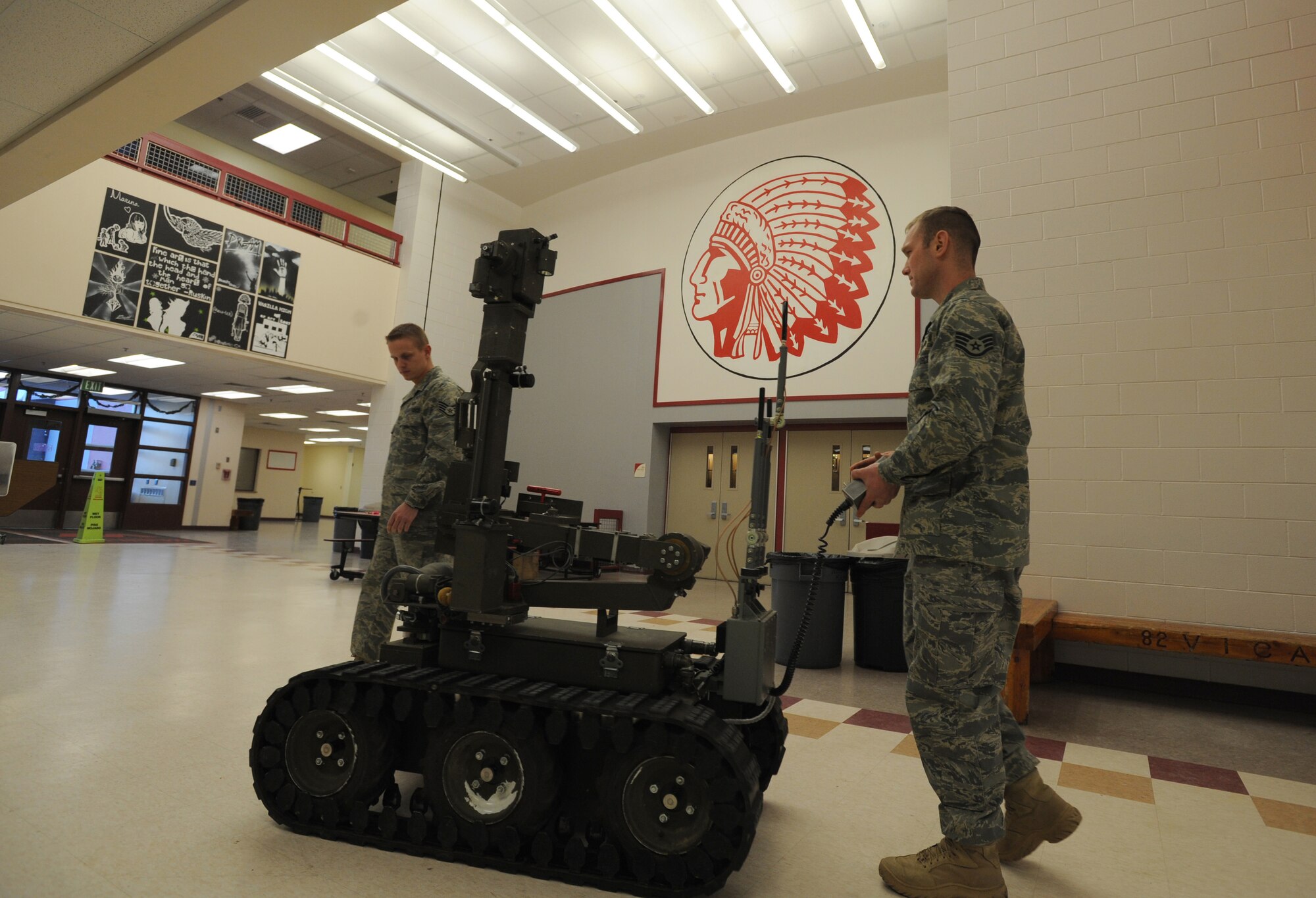 WASILLA, Alaska -- Staff Sergeants Matthew Hulsman and James Joiner, Elmendorf Explosive Ordnance Disposal unit, maneuver the bomb robot "Wolverine" through Wasilla High School to search for any traces of explosives Jan. 8. The Elmendorf EOD unit teamed up with the Anchorage and Wasilla Police Departments to absolve the bomb threat situation in the area. This was a significant moment in the military and local community relations under a no-notice, real world situation. (U.S. Air Force photo/Senior Airman Matthew Owens)