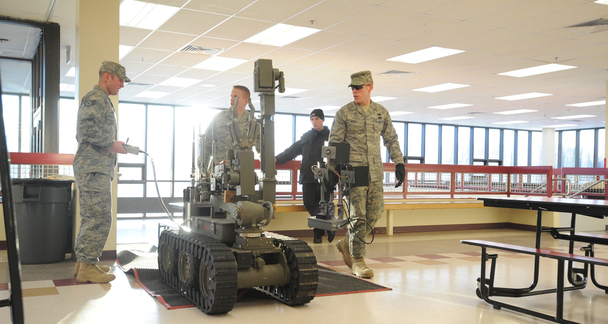 WASILLA, Alaska -- Airmen from the Elmendorf Explosive Ordnance Disposal team bring their Andros 6 bomb robot into Wasilla High School to prepare to scan for any traces of explosives within the school facility, Jan. 8. Elmendorf's EOD unit teamed up with the Anchorage and Wasilla Police Departments to absolve the bomb threat situation in the area. This was a significant moment in the military and local community relations under a no-notice, real world situation. (U.S. Air Force photo/Senior Airman Matthew Owens)