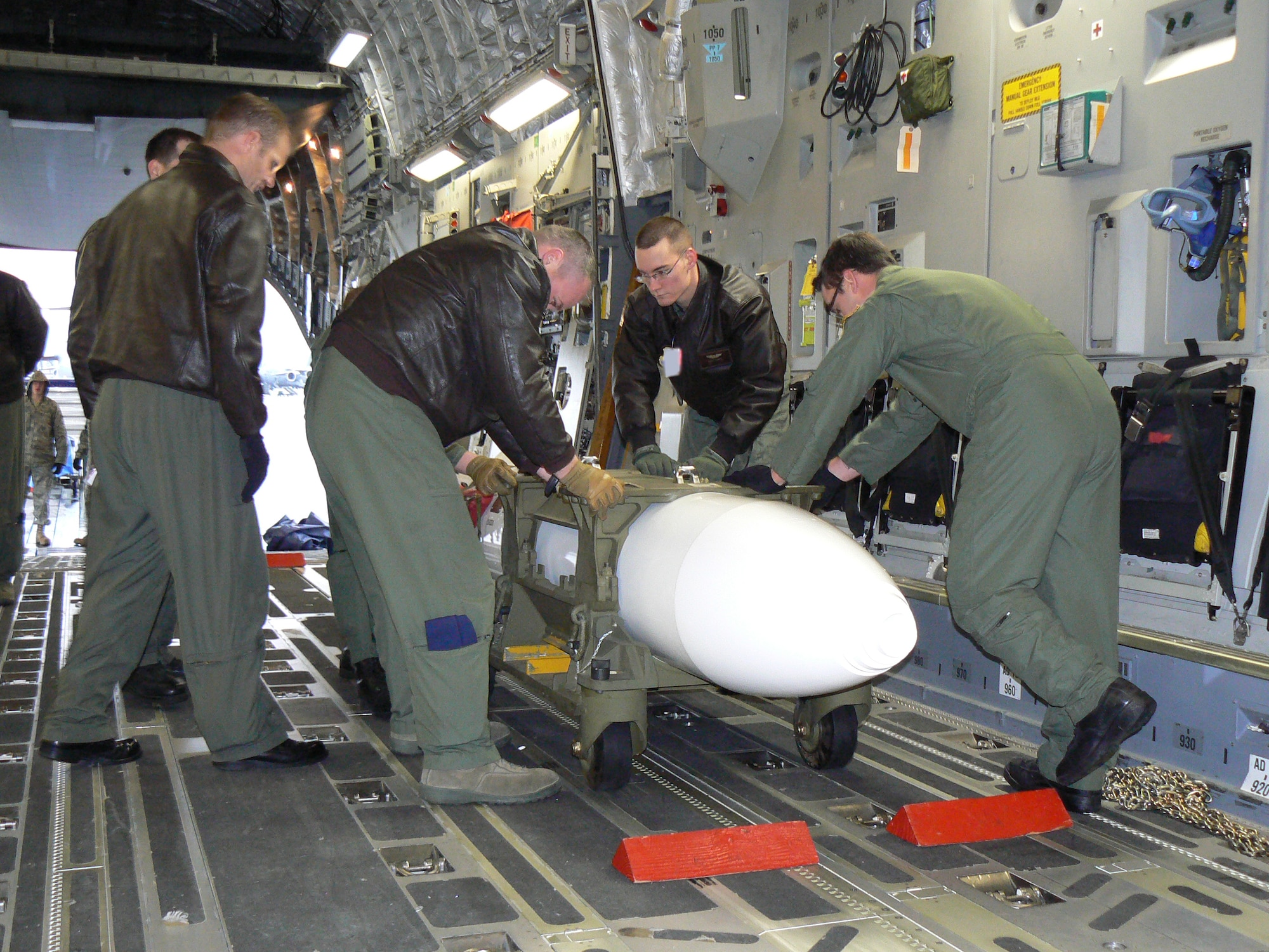 In continued readiness for the Prime Nuclear Airlift Force mission, 62nd Airlift Wing Airmen secure a nuclear cargo training aid inside a C-17 aircraft during a recent nuclear airlift mission training exercise. McChord’s 62nd Airlift Wing is the only organization in the U.S. Air Force tasked with the Prime Nuclear Airlift Force mission. Following a week-long inspection of the PNAF mission at McChord AFB, concluding Jan 12, inspectors rated the wing’s ability to complete the mission, “Satisfactory”, the highest possible rating. (U.S. Air Force photo/Capt. Casey Collier)
