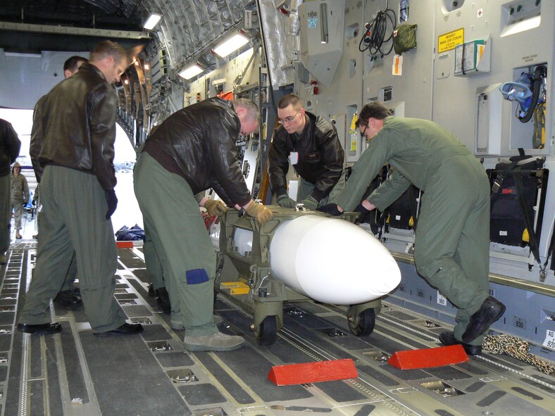 In continued readiness for the Prime Nuclear Airlift Force mission, 62nd Airlift Wing Airmen secure a nuclear cargo training aid inside a C-17 aircraft during a recent nuclear airlift mission training exercise. McChord’s 62nd Airlift Wing is the only organization in the U.S. Air Force tasked with the Prime Nuclear Airlift Force mission. Following a week-long inspection of the PNAF mission at McChord AFB, concluding Jan 12, inspectors rated the wing’s ability to complete the mission, “Satisfactory”, the highest possible rating. (U.S. Air Force photo/Capt. Casey Collier)