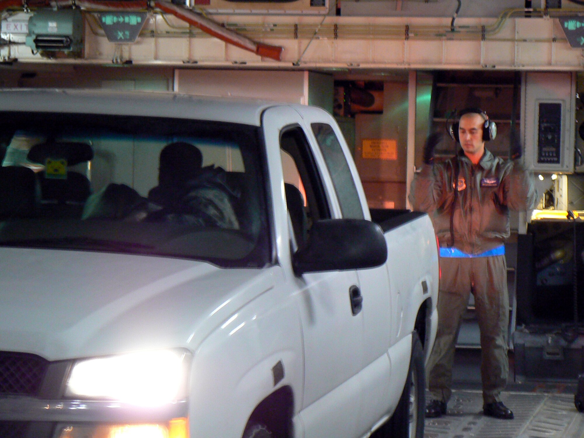 Senior Airman Alexander Osborn, 7th Airlift Squadron, along with a member of the 62nd Maintenance Group maintenance response team, back a government vehicle into a C-17 Globemaster III for transport to McChord from Moses Lake Jan. 1. The MRT drove two vehicles to the area to fix a disabled aircraft. After repairs were made, vehicles andmaintenance team hitched a ride back to McChord courtesy of the combat airlift transportation giant, the C-17. (Courtesy photo)