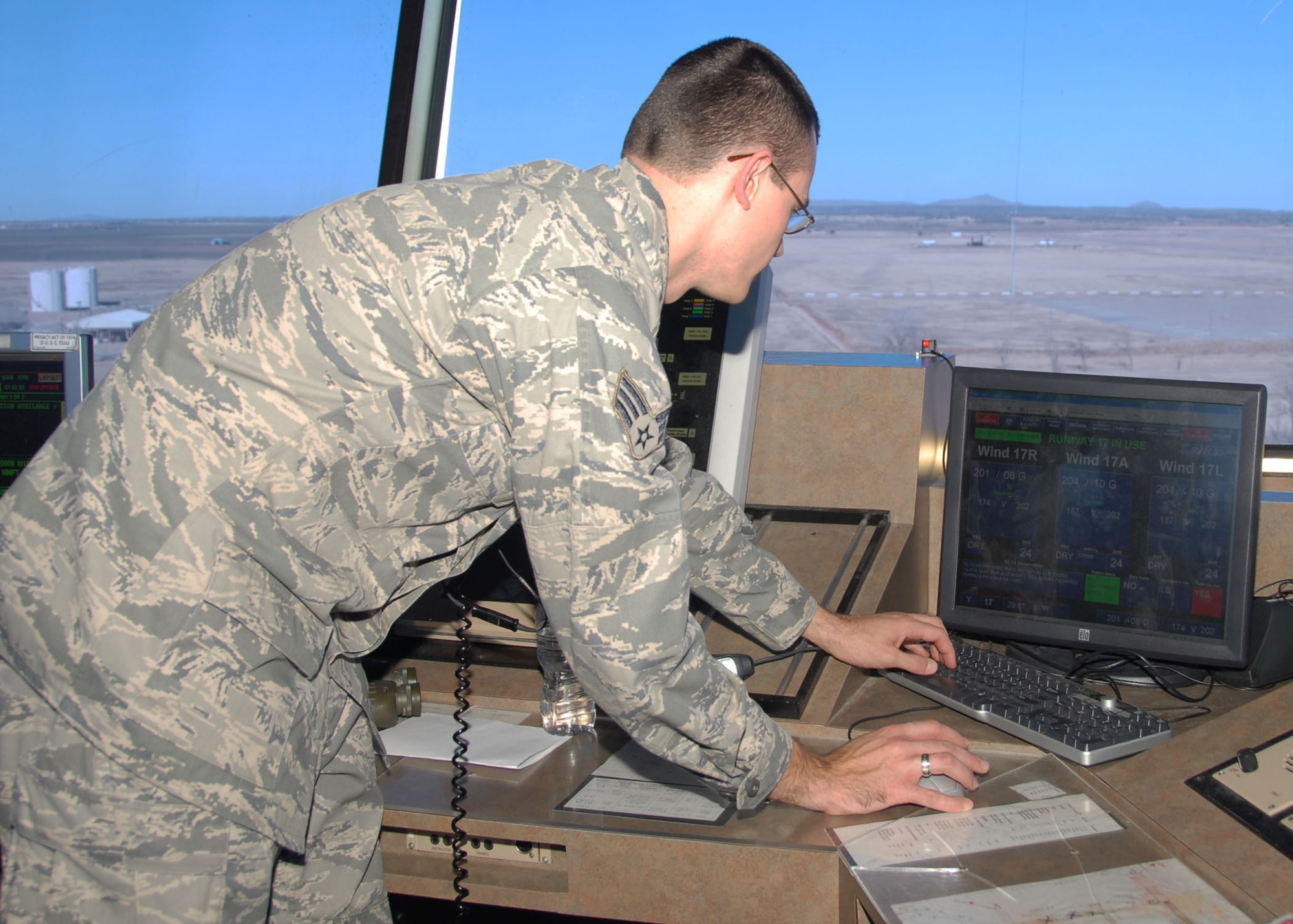 ALTUS AIR FORCE BASE, Okla. -- Senior Airman Christopher Hake, 97th Operations Support Squadron, changes the Flight Progress Chart on the base Airfield Automation System. The AFAS has weather watches, warnings and the sunrise and sunset times. It also reduces man-hours by nearly one hour a day and drops the rate of miscommunications to almost zero. (U.S. Air Force photo/Airman 1st Class Marianne E. Lane)