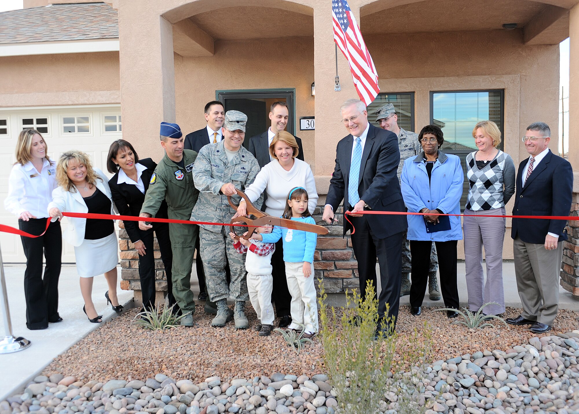 Lt. Col William Walker, 49th Material Maintenance Group, and his family cut the ribbon on their new home at the Soaring Heights Ribbon Communities ribbon cutting ceremony at  Holloman Air Force Base, N.M, Jan. 8. The Walker Family was the first family to enter the new housing.
