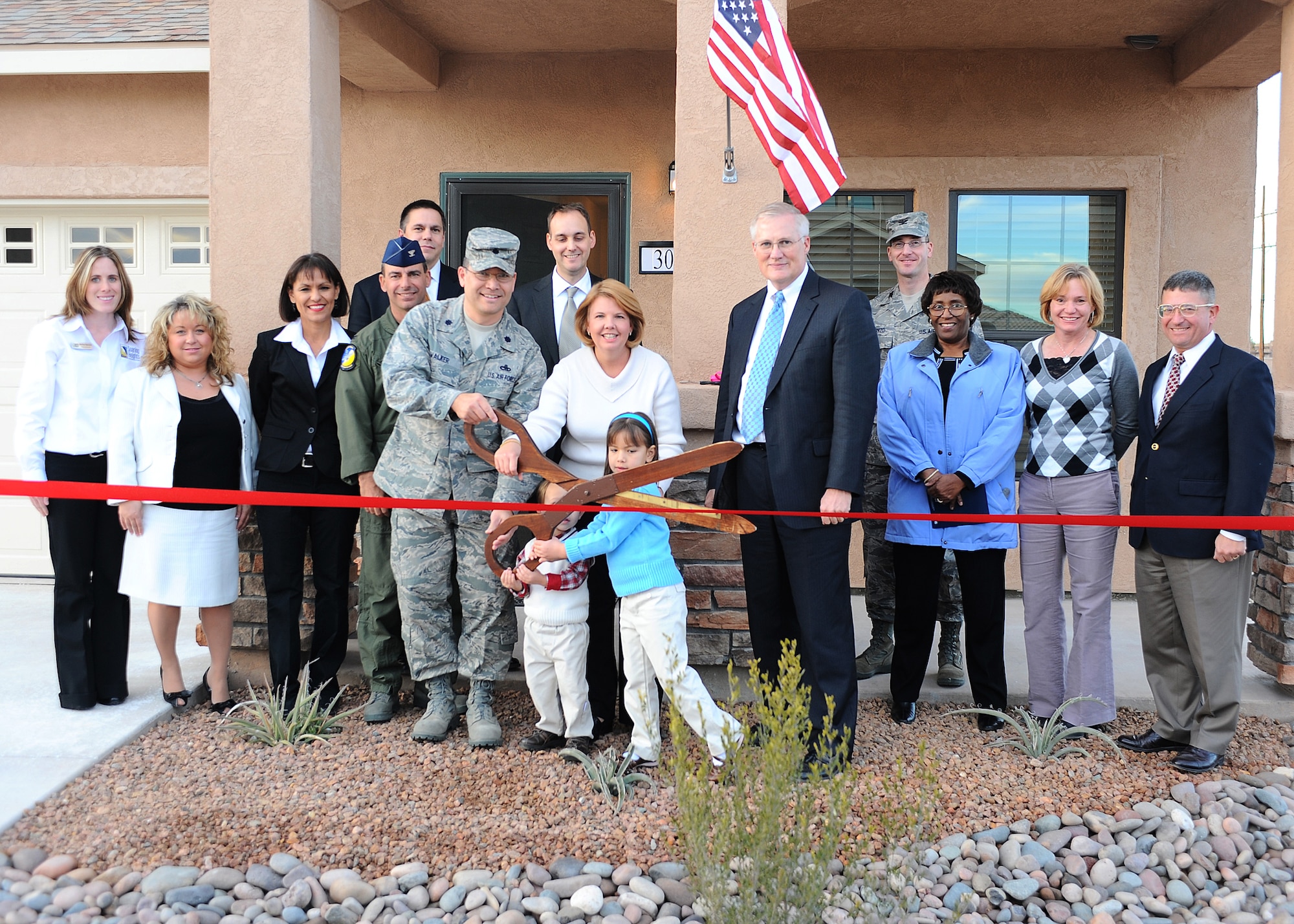 Lt. Col. William Walker 49th Material Maintenance Group and his family prepare to cut the ribbon on their new home at the Soaring Heights Communities ribbon cutting ceremony at Holloman Air Force Base, N.M, Jan. 8. The Walker Family was the first family to enter the new housing.