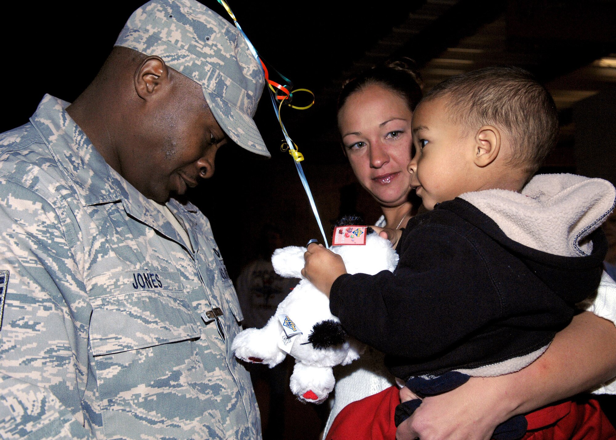 Tech. Sgt. Benjamin Jones reunites with his family after a six month deployment to Southwest Asia, Jan. 5,  at Holloman Air Force Base, N.M. Sergeant Jones is a kennel master assigned to the 49th Securtiy Forces Squadron.(U.S. Air Force photo/Senior Airman Anthony Nelson)