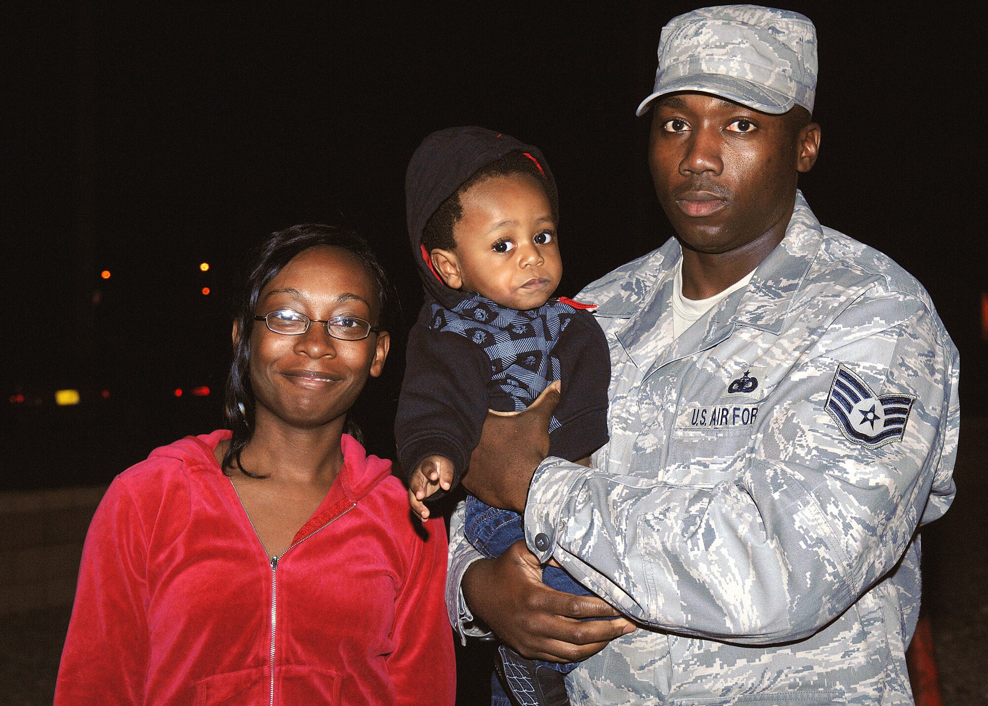 Staff Sgt. Rufus Watson, 49th Security Forces Squadron, poses for a picture with his family at Holloman Air Force Base, N.M., Jan. 5, upon his return from a six month deployment to Souwthwest Asia. (U.S. Air Force photo/Senior Airman Anthony Nelson)