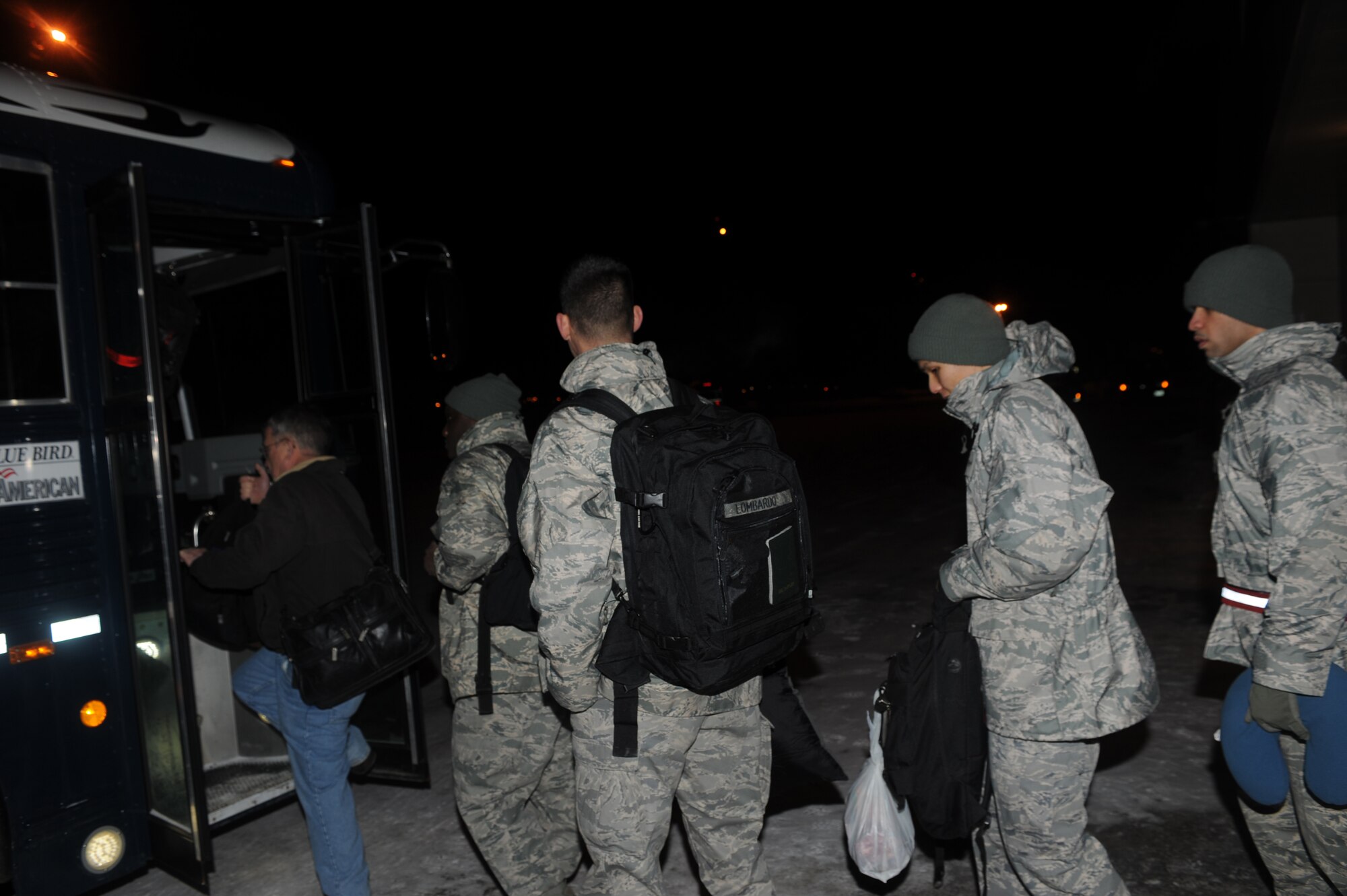 ELMENDORF AIR FORCE BASE, Alaska-- Airmen from the 90th Fighter Squadron board a bus to get taxied to their C-17 for the first F-22 AEF deployment, Jan. 9.The 90th Fighter Squadron will be deploying to Guam for a 90-day rotation to test the real world deployment capabilities of the F-22. (U.S. Air Force photo/Senior Airman Matthew Owens)