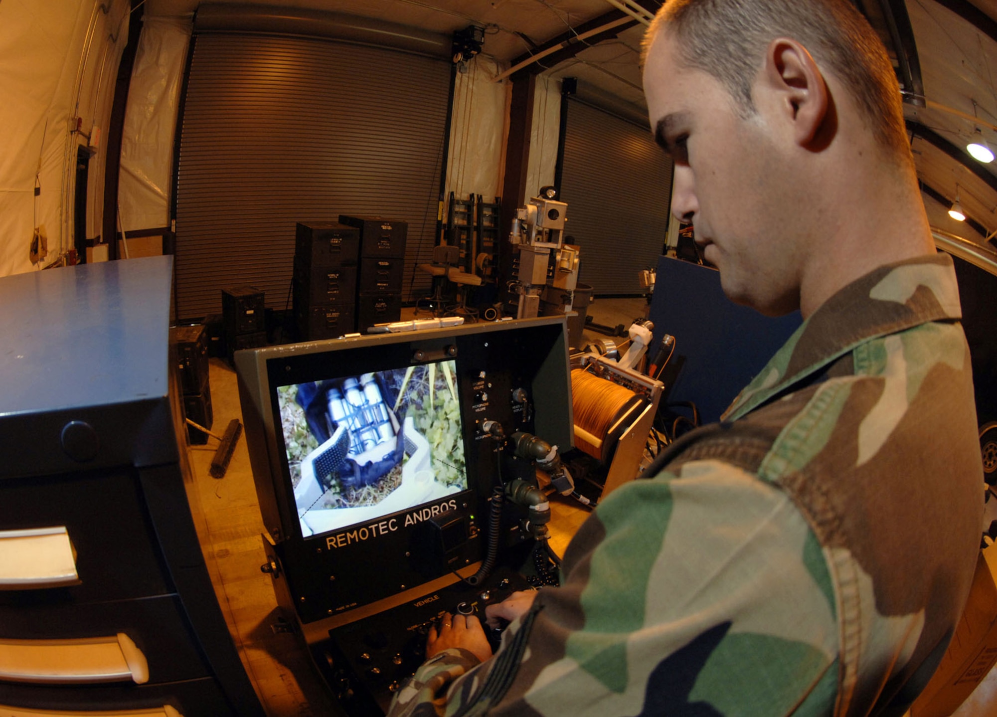 Robotic devices have lessened the danger of handling suspicious packages and unexploded ordnance. An EOD specialist remotely works on a dangerous device (U.S. Air Force photo)