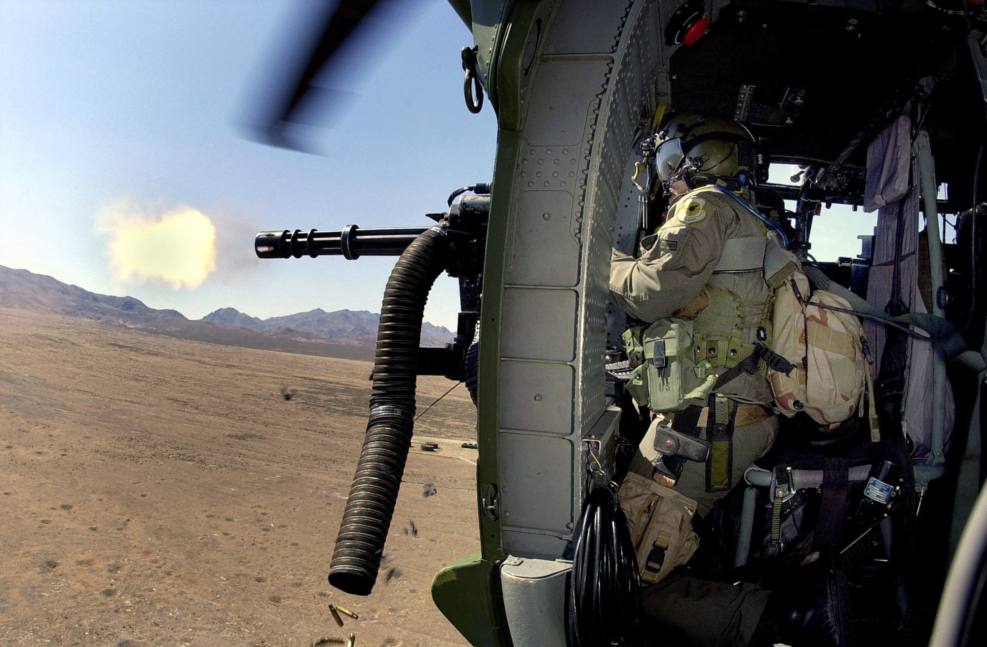 66th Rescue Squadron gunner firing 7.62mm minigun. (U.S. Air Force photo)