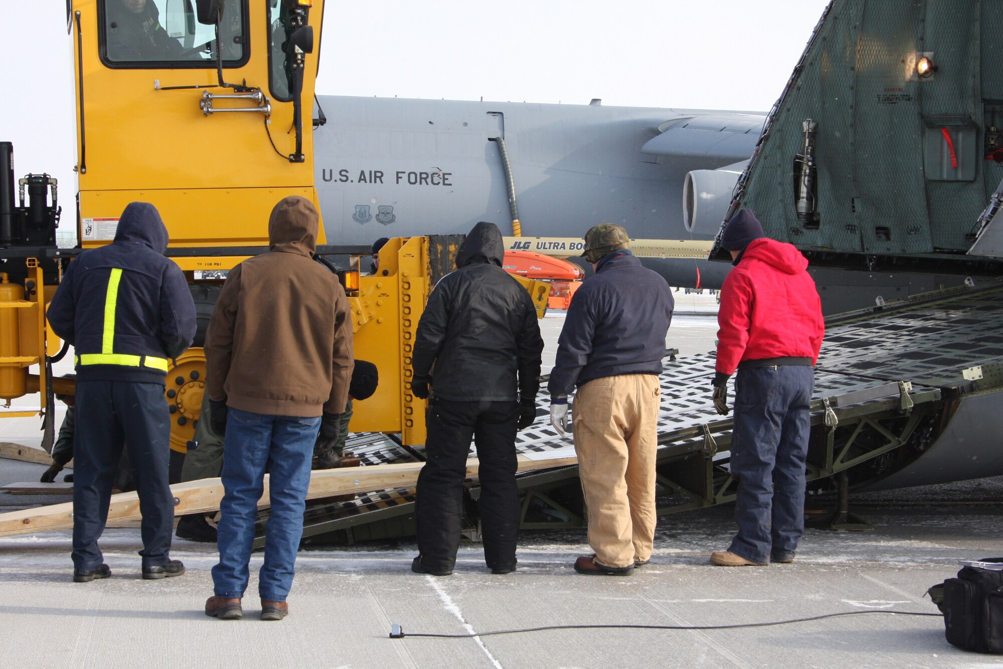 WRIGHT-PATTERSON AFB, Ohio - A snow plow is loaded onto a 445th Airlift Wing C-5 aircraft Jan. 9, 2009, during a training exercise.  The snow plow provides the right combination of large and heavy equipment for training purposes.  The C-5 is the largest aircraft in the Air Force inventory and can carry a maximum cargo weight of 270,000 pounds. (Air Force photo/Stacy Vaughn) 