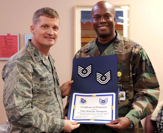 Staff Sgt. Malcolm Thompson, 99th Medical Operations Squadron aerospace medicine services technician, receives his Technical Sergeant STEP promotion stripes from Col. Dave Belote, the 99th Air Base Wing commander Dec. 23. (U.S. Air Force Photo/ Airman 1st Class Stephanie Rubi)