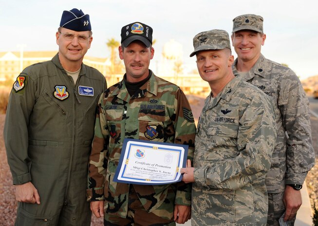 Tech. Sgt. Christopher Jayne (center), 99th Civil Engineering Squadron, civil/structural team construction inspector, gets STEP promoted to the rank of Master Sergeant by Maj. Gen. Stephen Hoog (left), United States Air Force Warfare Center commander, Col. Dave Belote, 99th Air Base Wing commander, and Lt. Col. Markus Henneke, 99th Civil Engineering Squadron commander, Jan. 6. (U.S. Air Force Photo/Senior Airman Larry E. Reid Jr.)
