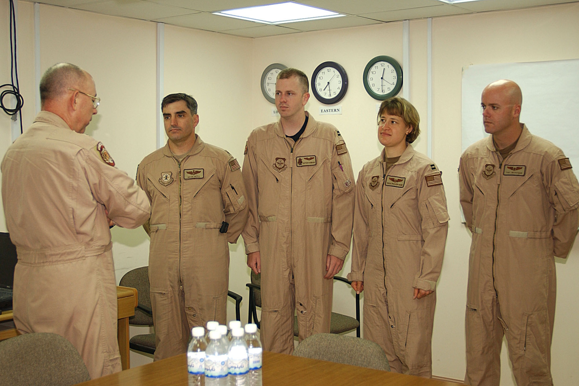 Gen T. Michael Moseley (left), USAF Chief of Staff, presents the Distinguished Flying Cross to (facing forward, left to right) Maj. Brian Neitz, Capt. Nathan Howard, Capt. Tricia Paulsen-Howe and TSgt. Jim Pittman. On April 7, 2003, this KC-135 crew put themselves in harm's way to help the crew of a downed F-15E. (U.S. Air Force photo)