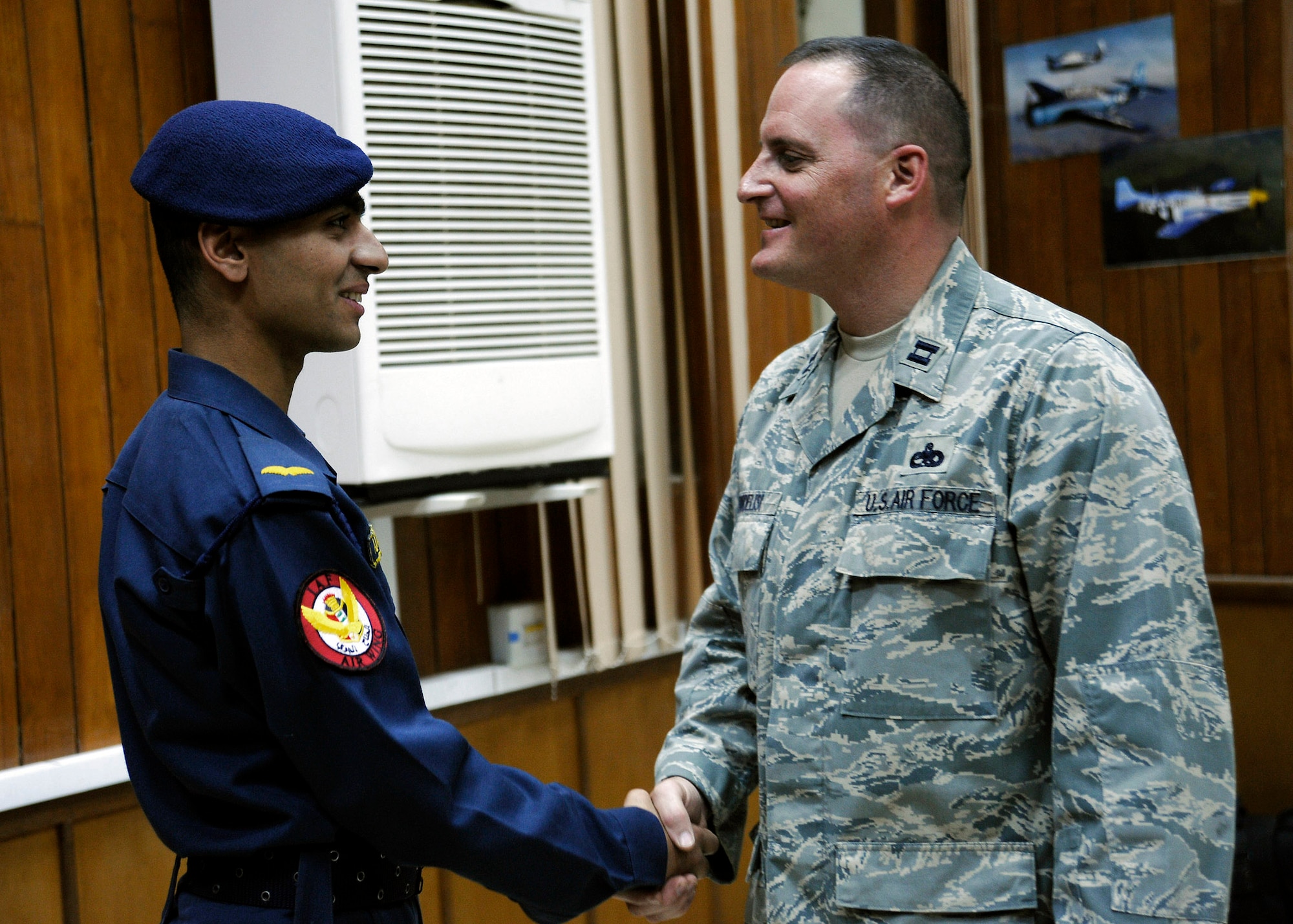 Iraqi air force cadet Ali-Talib thanks Capt. Tom Fiordelisi for the training he received at the Iraqi Military Academy al Rustamiyah in Iraq. Captain Fiordelisi, an air adviser with the 321st Air Expeditionary Training Group, taught courses in English, airpower, followership and leadership for the Iraqi air force training wing. (U.S. Air Force photo/Staff Sgt. Paul Villanueva II) 

