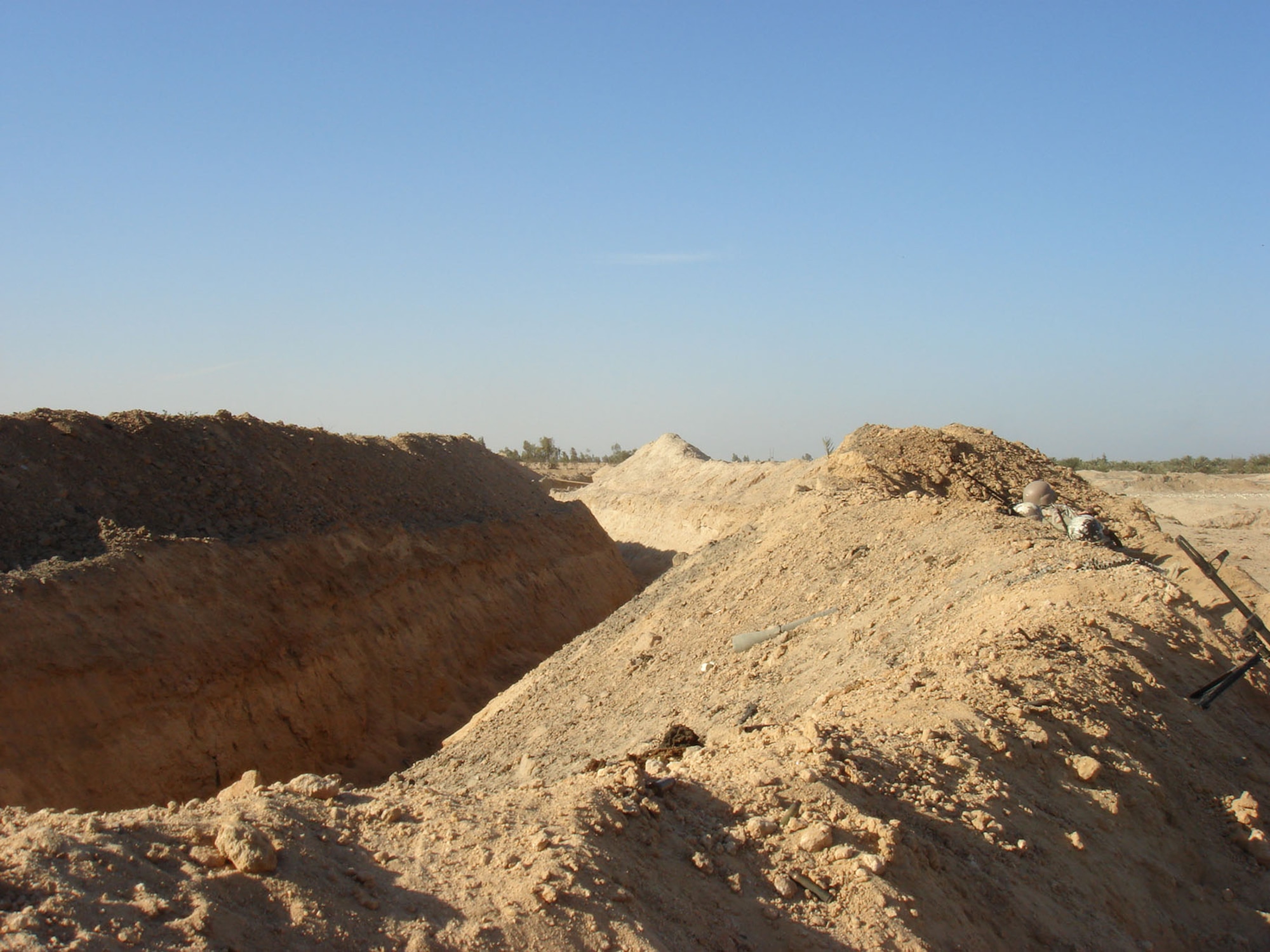 Enemy trench that the GBU-12 hit. The trench was 10 feet deep and the berm in front of it was 10 feet high, making the enemy position very difficult to assault. (U.S. Air Force photo)