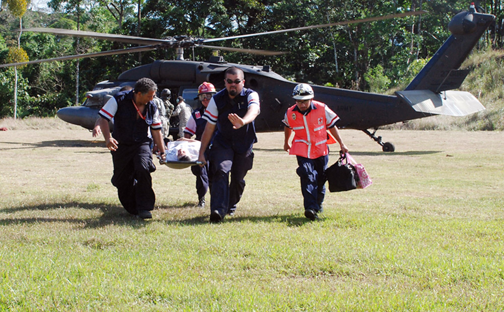 Members of the Costa Rican Red Cross transport a 65-year-old female earthquake victim here from a Joint Task Force-Bravo helicopter to a waiting ambulance Jan. 10 in San Miguel, Costa Rica. Four JTF-Bravo helicopters and 34 American servicemembers deployed from Soto Cano Air Base, Honduras, at the request of the Costa Rican government to provide lifesaving support to those affected by the earthquake. (U.S. Air Force photo/1st Lt. Candace Park) 
