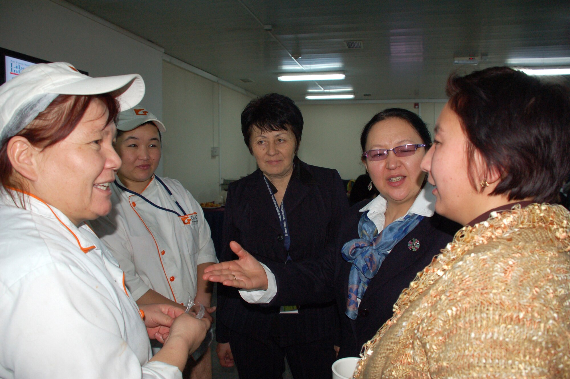 Members of the Kyrgyzstan Congress of Women talk with Kyrgyz employees at the dining facility during a Jan. 8 tour of Manas Air Base, Kyrgyzstan. The group, which consisted of female civic and business leaders from throughout Kyrgyzstan, visited the base to meet with Airmen and to learn more about the mission and the contributions of women who serve there. (U.S. Air Force photo/Maj. Damien Pickart) 
