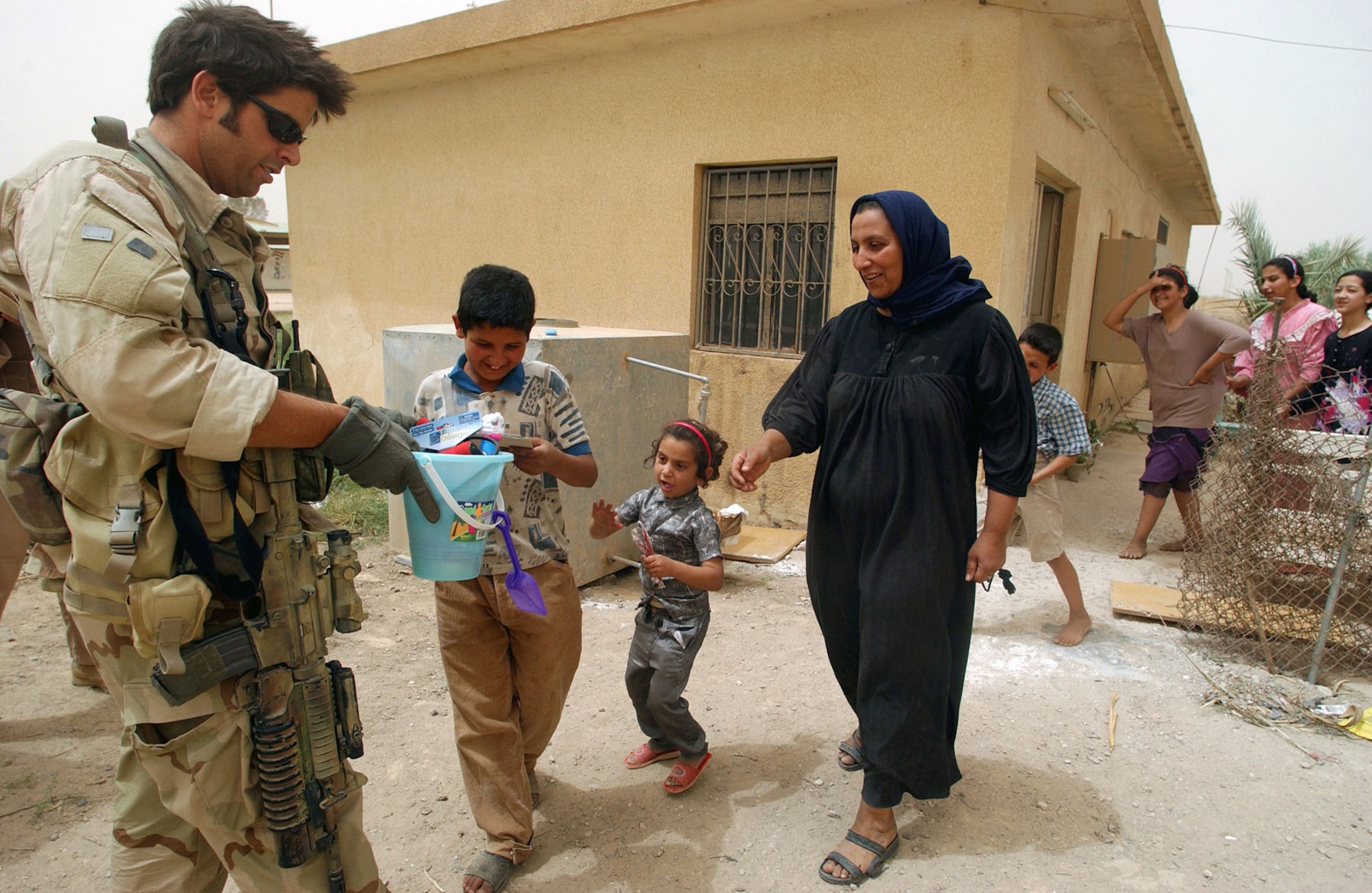 Combat Controller Staff Sgt. David Overton, passing out candy and toys to Iraqi children in Baghdad. (U.S. Air Force photo)