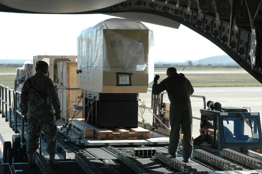 Airmen from the 60th Aerial Port Squadron load cargo onto a C-17 Globemaster III. Travis crewmembers departed Jan. 10 with equipment to support humanitarian aid operations in Africa. (U.S. Air Force photo/Staff Sgt. Shaun Emery)