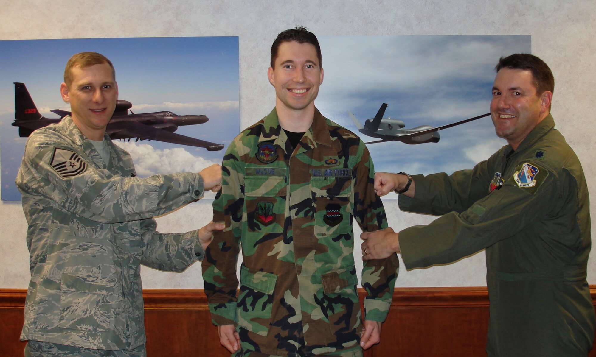 Master Sgt. Christopher Lee and Lt. Col. David Anderson, Det 2, 53d Test and Evaluation Group commander, "tack" on stripes to newly promotedTech. Sgt. Patrick McCue.  Sergeant McCue received his new stripe via the Stripes for Exceptional Performers program Dec 24 at Beale Air Force Base, Calif.  (Courtesy photo) 