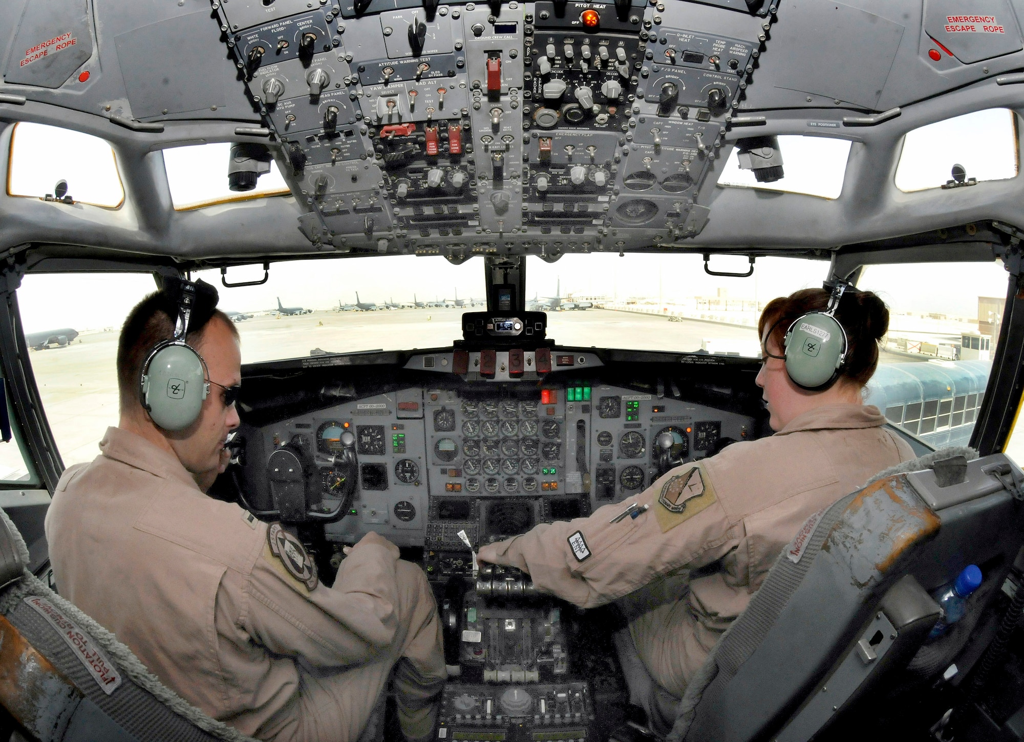 1st Lt. Seth Simpson and Staff Sgt. Jessica Earls perform preflight procedures in the cockpit of the E-8C Joint STARS Jan. 7 at an air base in Southwest Asia. Lieutenant Simpson is a co-pilot assigned to the 7th Expeditionary Airborne Command and Control Squadron and Sergeant Earl is a flight engineer assigned to the 7th EACCS. They are deployed from Robbins Air Force Base, Ga. (U.S. Air Force photo/Tech. Sgt. Michael Boquette) 
