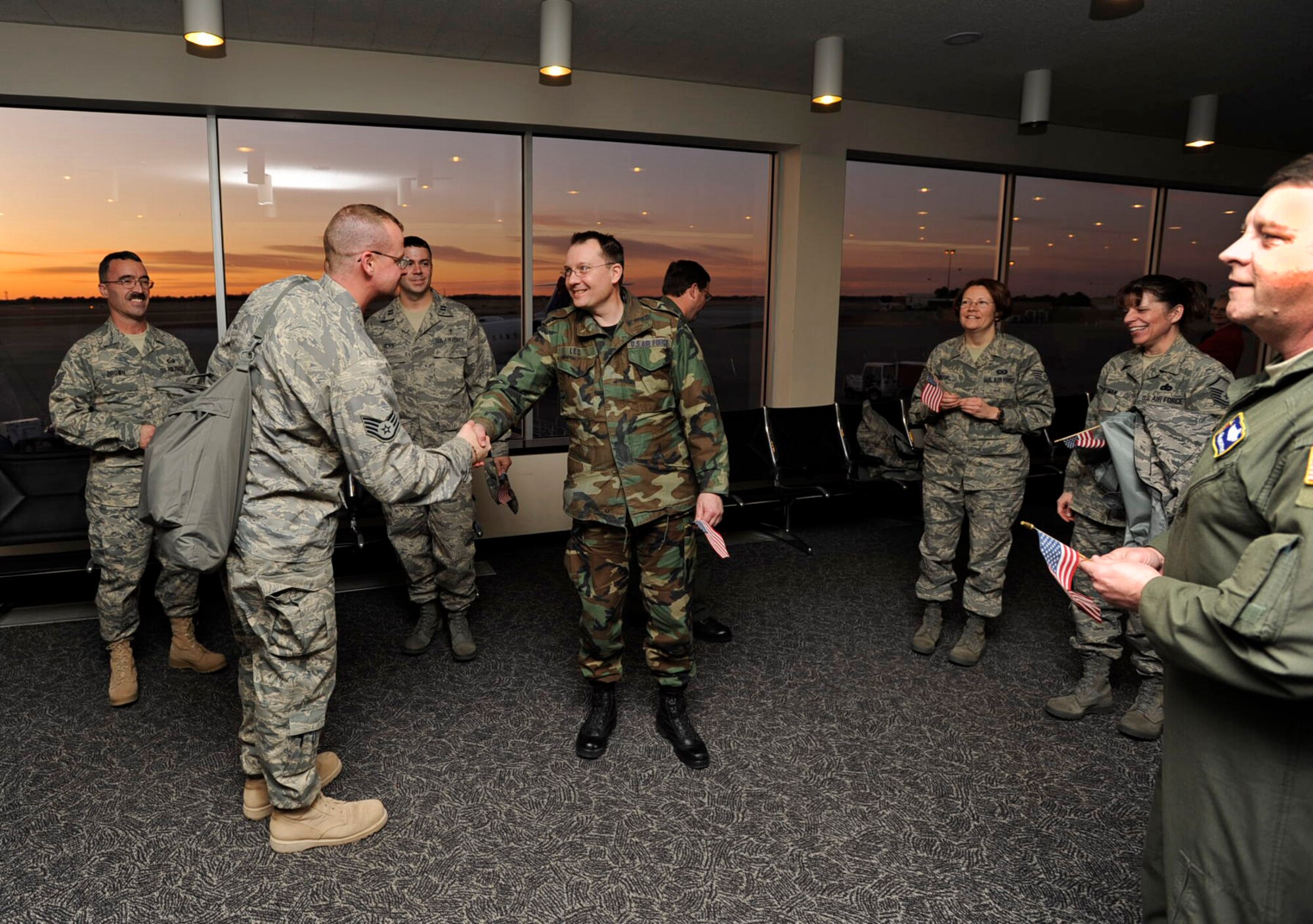 Staff Sgt. Scott Gaitley is greeted by Lt. Col. Lawrence Lee and other members of the 931st Air Refueling Group at Wichita Mid-Continent Airport on Jan. 10. Sergeant Gaitley, 931st historian, returned from a deployment to Iraq where he was responsible for recording the histories of deployed Air Force units. The 931st ARG is an Air Force Reserve unit at McConnell Air Force Base, Kan. (U.S. Air Force photo/Tech. Sgt. Jason Schaap)