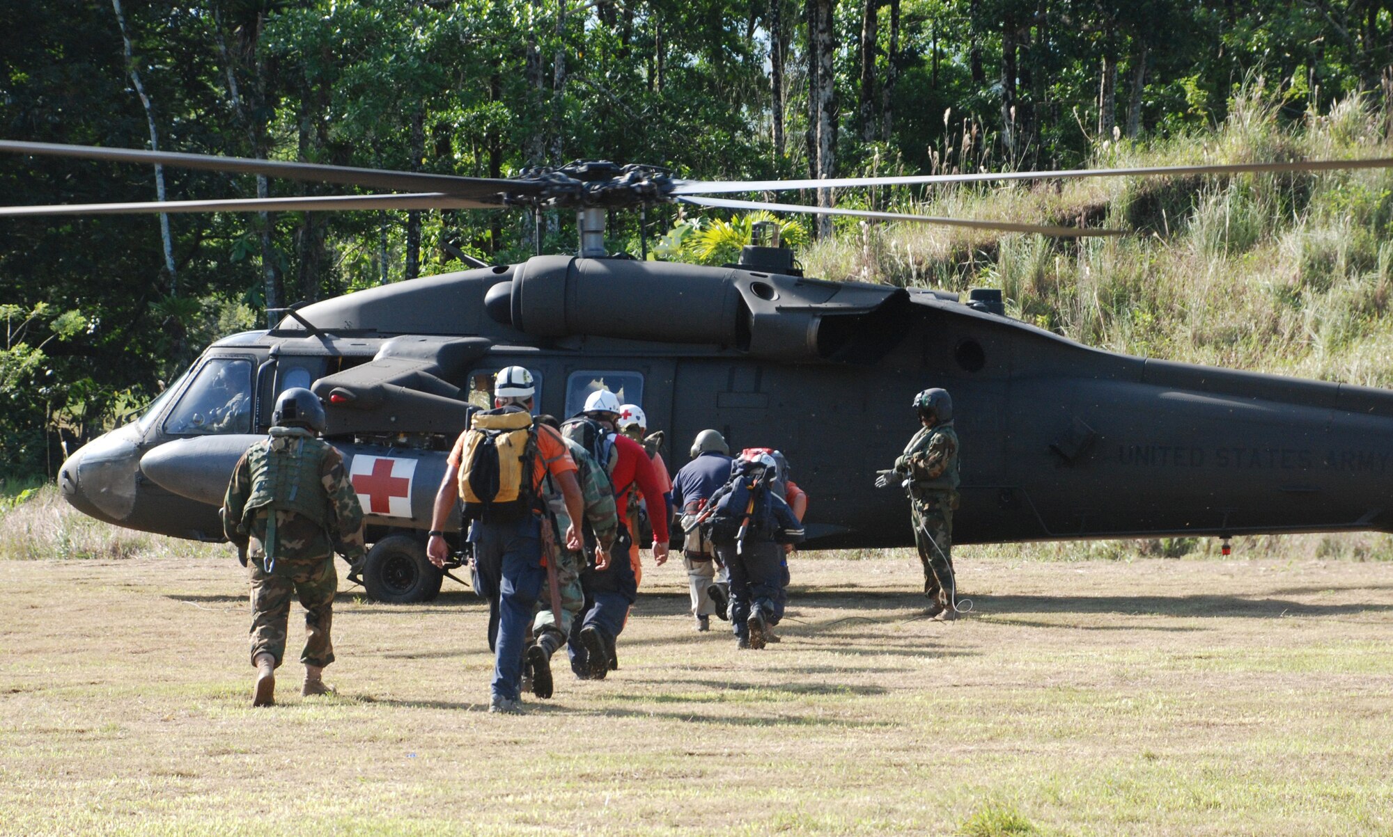 SAN MIGUEL, COSTA RICA--Search and rescue volunteers here load a Joint Task Force-Bravo Blackhawk helicopter Sunday to be transported to areas affected by the earthquake. Four helicopters and 34 servicemembers from JTF-Bravo are deployed here at the request of the Costa Rican government to provide humanitarian assistance. (U.S. Air Force photo/1st Lt. Candace Park)