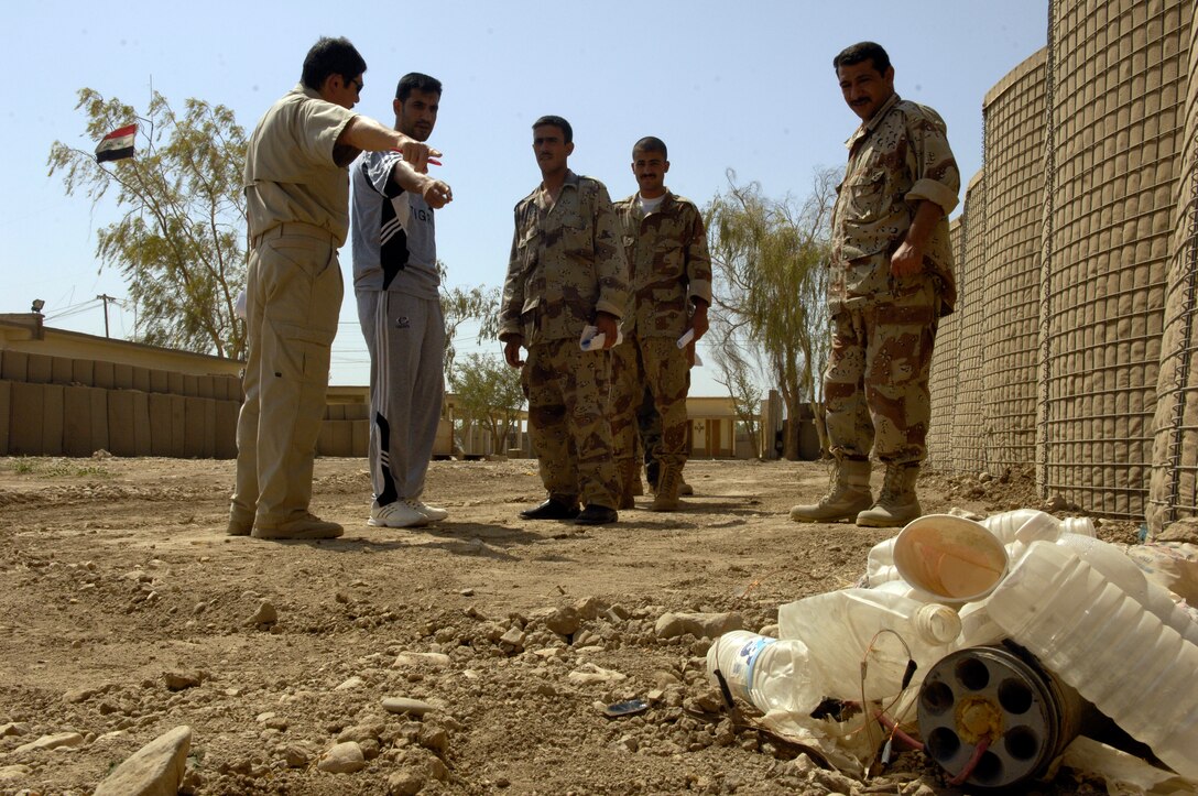 Officers with the Iraqi 5th Department of Border Enforcement team walk an improvised explosive device identification lane with their instructors with the U.S. Border Enforcement Transition Team at Camp Echo, Iraq, July 23, 2008. (U.S. Air Force photo by Airman 1st Class Matthew Plew/Released)