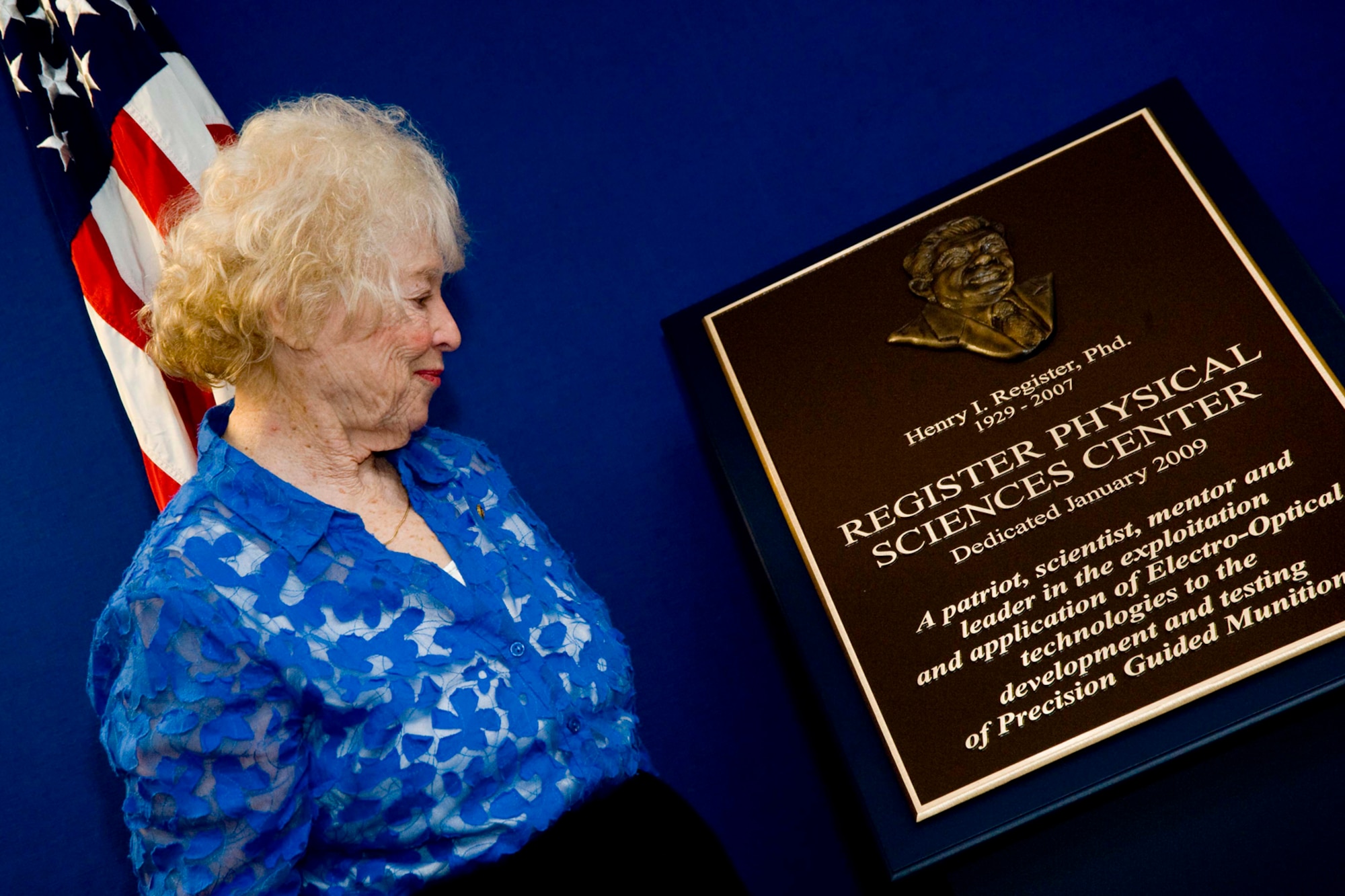EGLIN AIR FORCE BASE, Fla. -- Annette Register views a plaque of Dr. Henry Register, who was honored Jan. 5 with the renaming of Building 22 to the Register Physical Sciences Center and a Memorial placed in its foyer, in recognition of his outstanding contributions to military and country. (US Air Force photo/ Debi Haussermann)