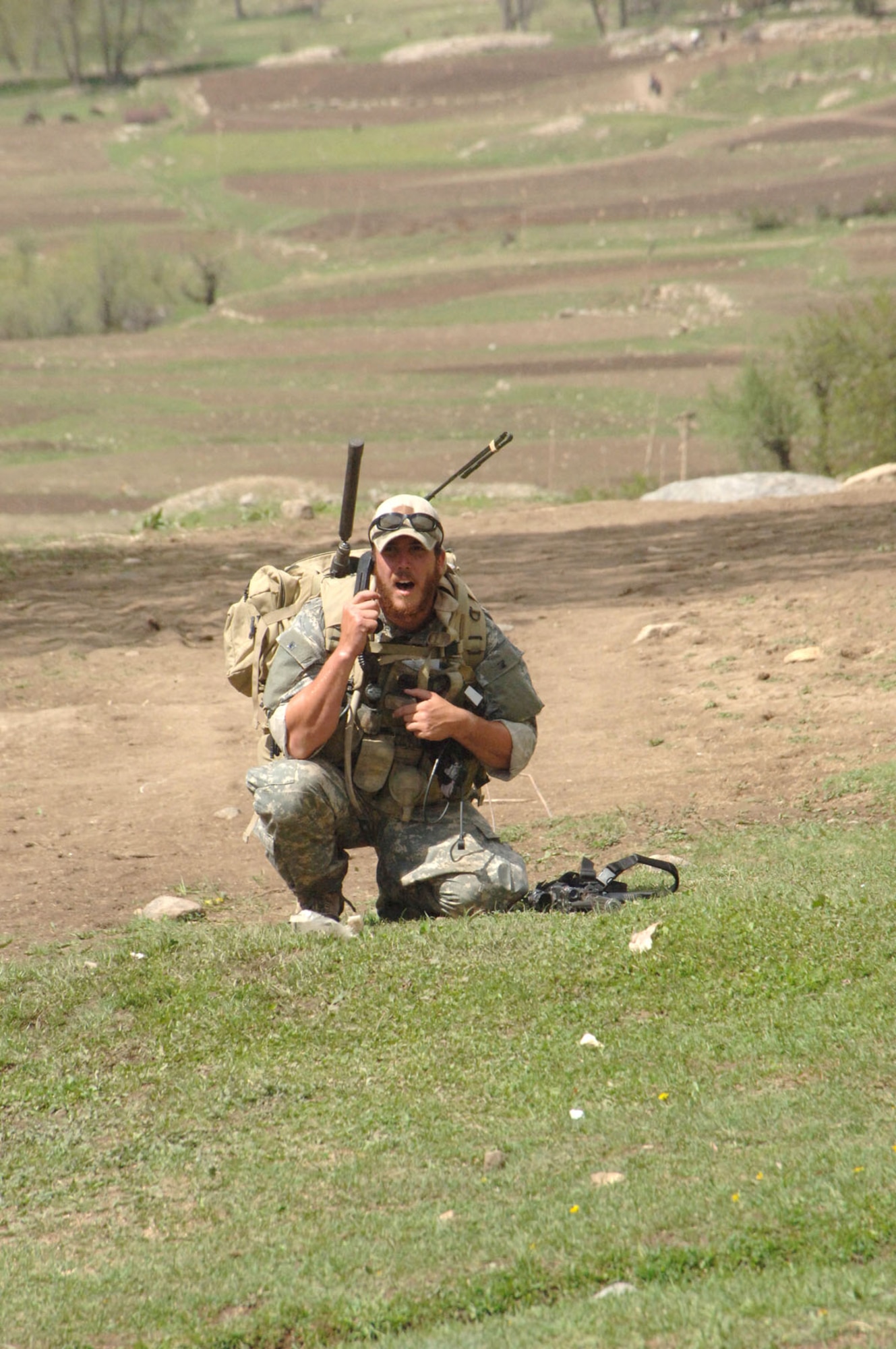 Air Force Joint Terminal Attack Controller (JTAC) talking on the radio in support of a U.S. Army Special Forces team in Afghanistan. (U.S. Air Force photo)